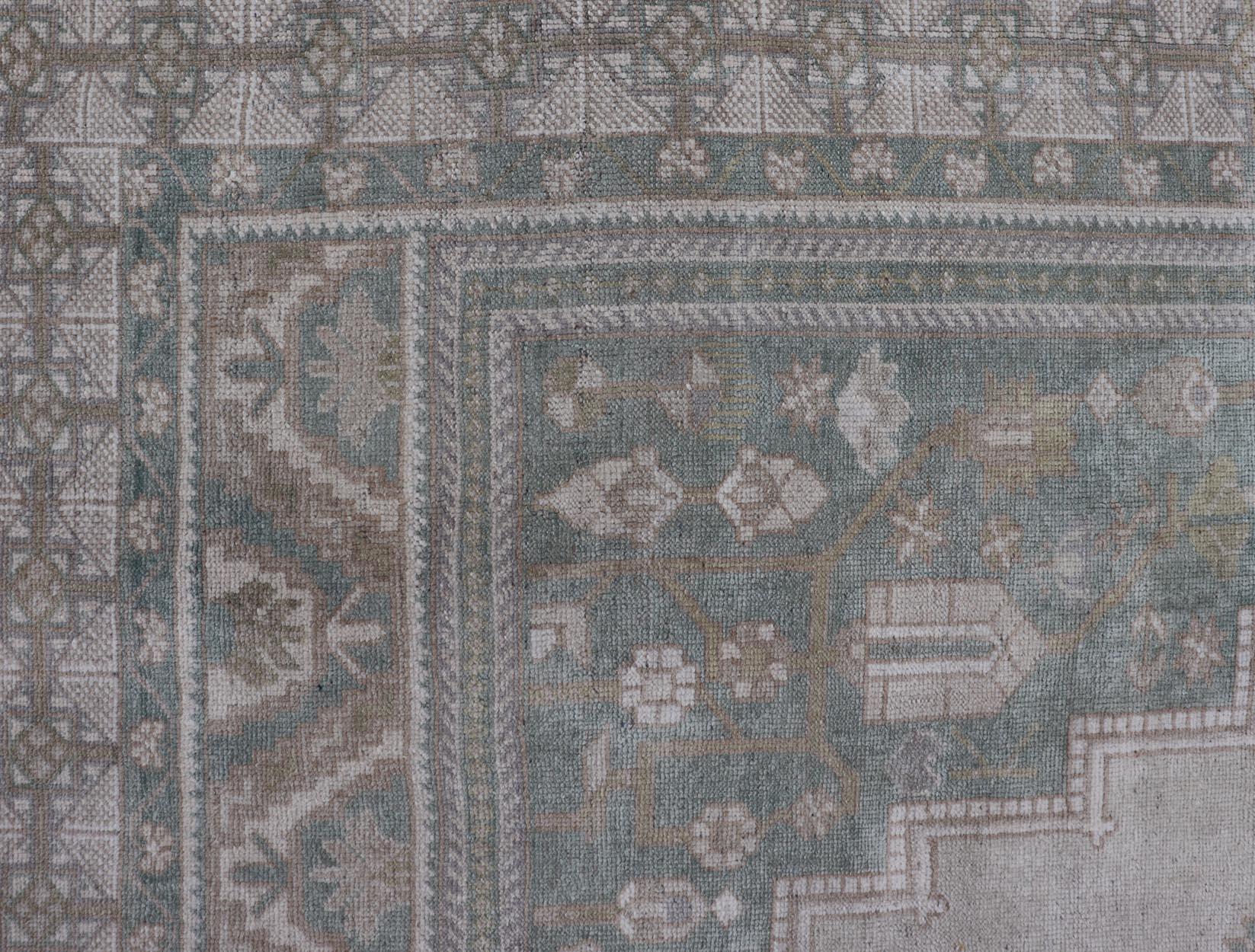 Measures: 6'4 x 11'9 
Turkish Vintage Oushak Rug With Medallion in Muted Light Green and Cream. Keivan Woven Arts / rug TU-MTU-4665 country of origin / type: Turkey / circa 1940 

This vintage muted Turkish Oushak Rug has been hand-knotted in wool