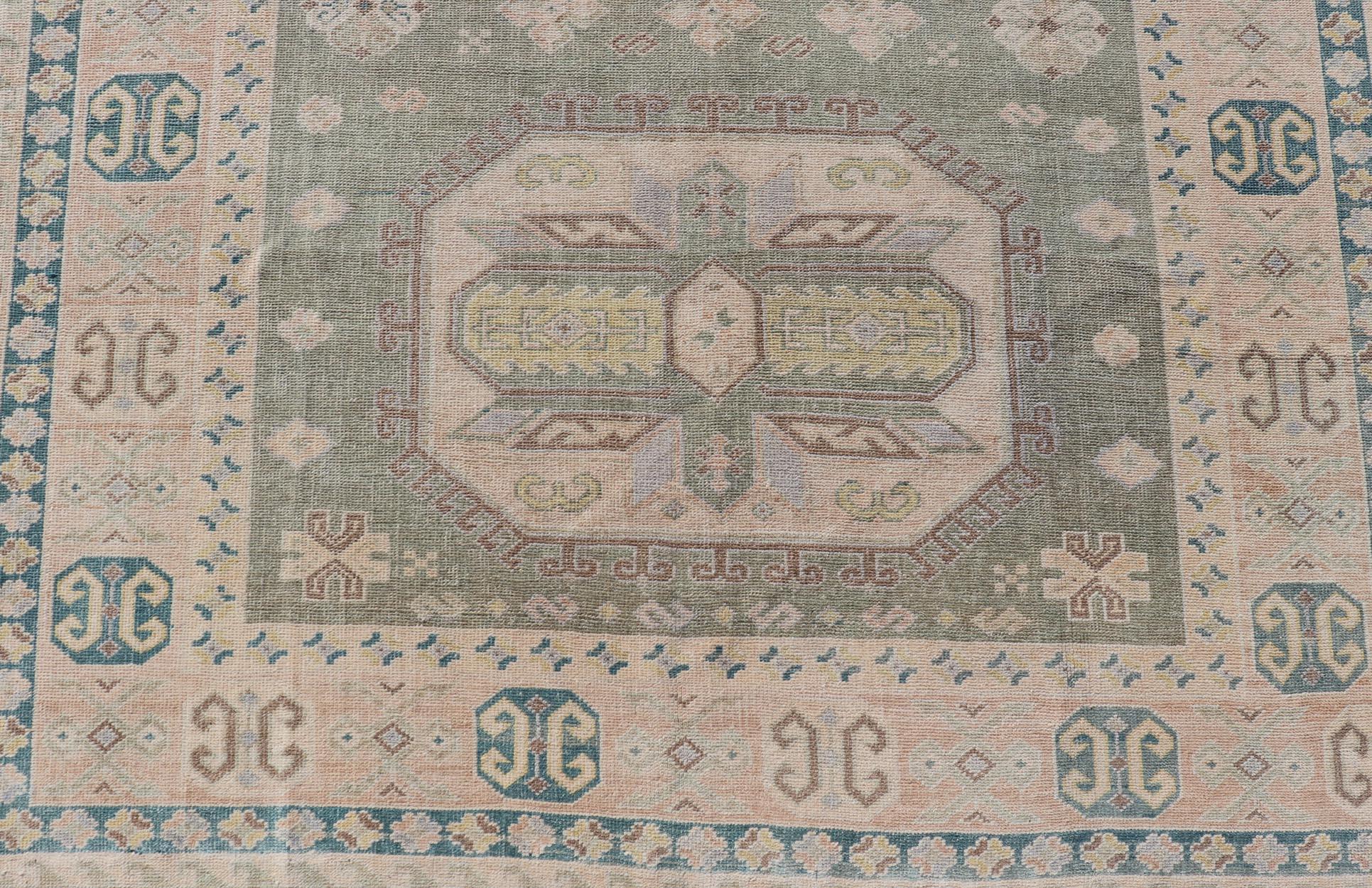 Measures: 6'0 x 9'10 
Turkish Vintage Tribal Medallion Oushak in Muted Green, Blue, and Cream. Country of Origin: Turkey; Type: Oushak; Design: Medallion, Tribal Medallion, All-Over, Tribal; Keivan Woven Arts; rug TU-MTU-991. mid-20th century.