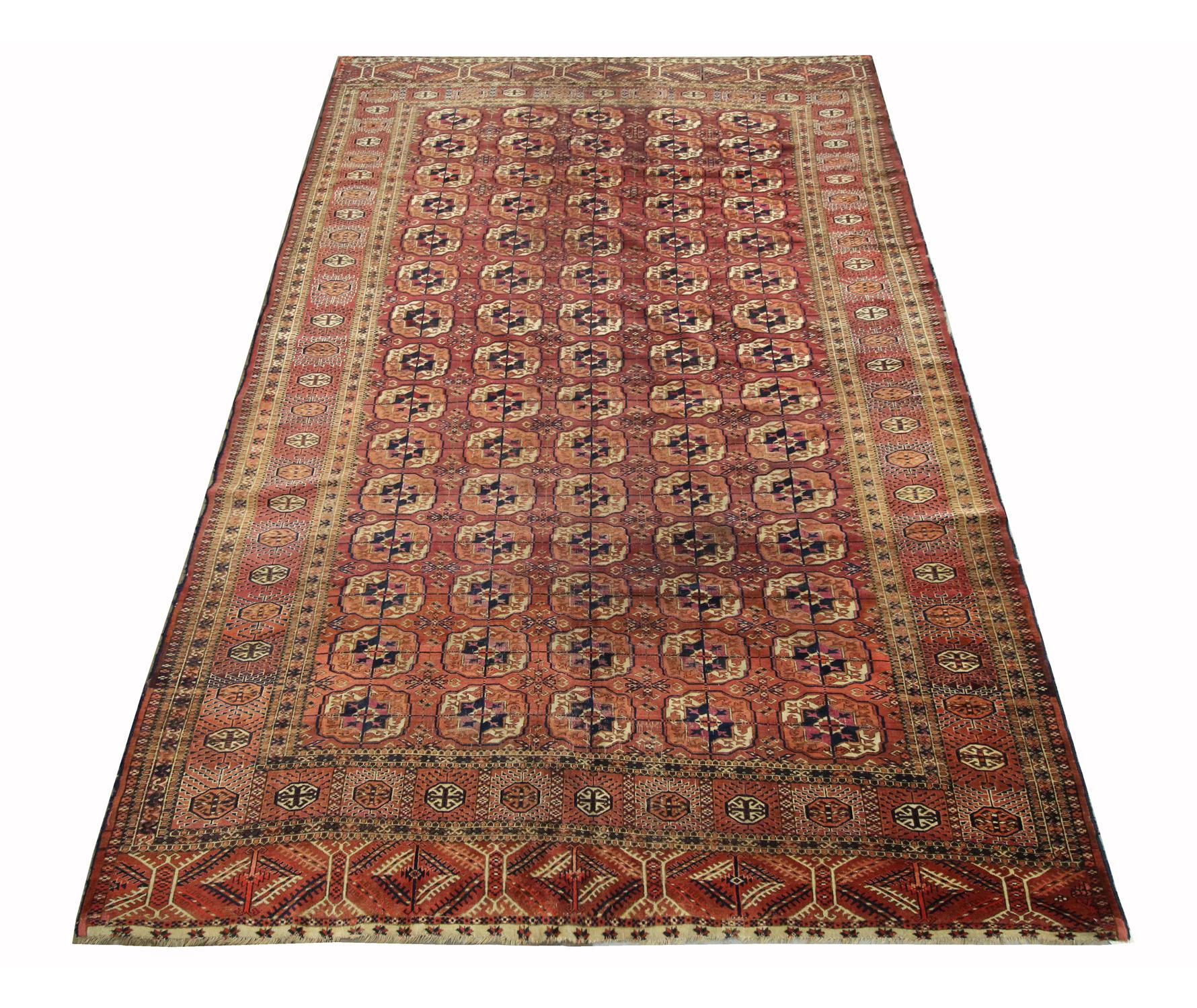 This fine wool is an Indian wool rug that was woven by hand in the 1930s. It features a traditional medallion design with a rich orange background that has been decorated with a delicate medallion and symmetrical surrounding design and border.