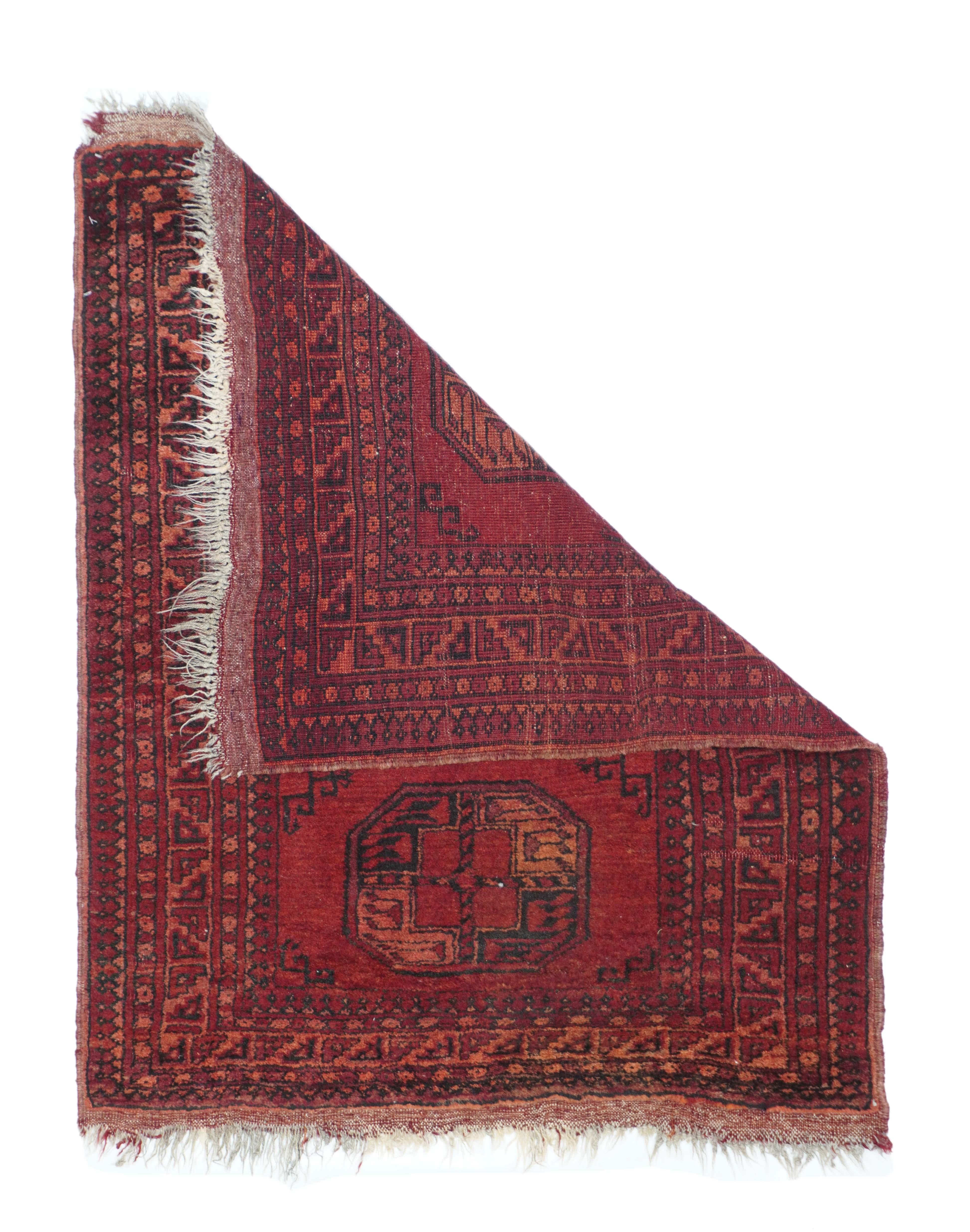 Turkmen rug measures: 2'11'' x 3'7''. This Central Asian nomadic scatter show three quartered octagonal emblematic tribal guls in dark blue and burnt rose with half minor gul side fillers on an abrashed madder red ground. Burnt rose main border of