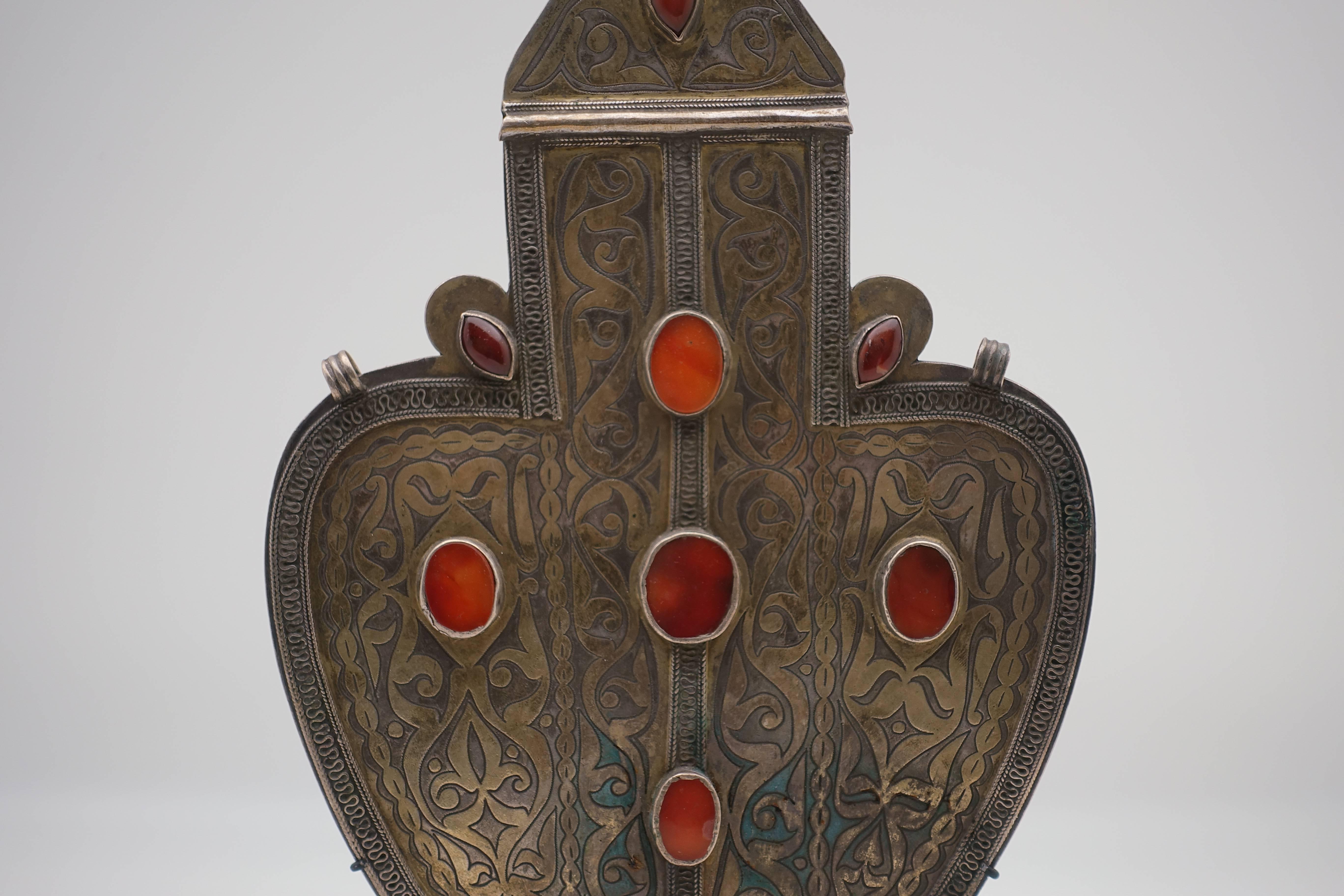 Coin-silver Turkmen heart pendant from Turkmenistan, boarding Afghanistan. Antique silver pendant from the early 1900s. Hand-tooled coin silver with nine carnelian settings, mounted on a custom, black painted metal base.