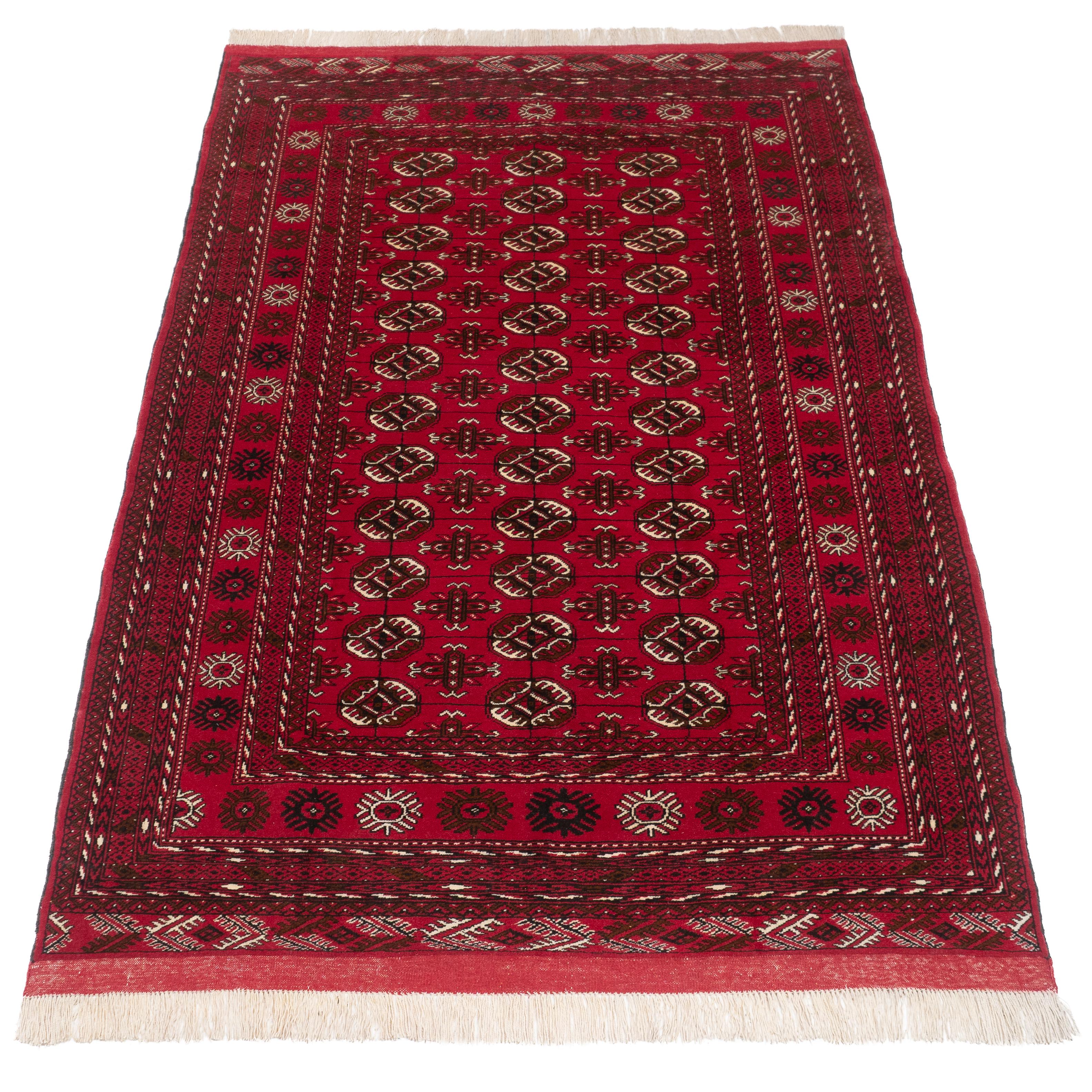 A Turkmen Tekke handwoven rug, approximately 6'11