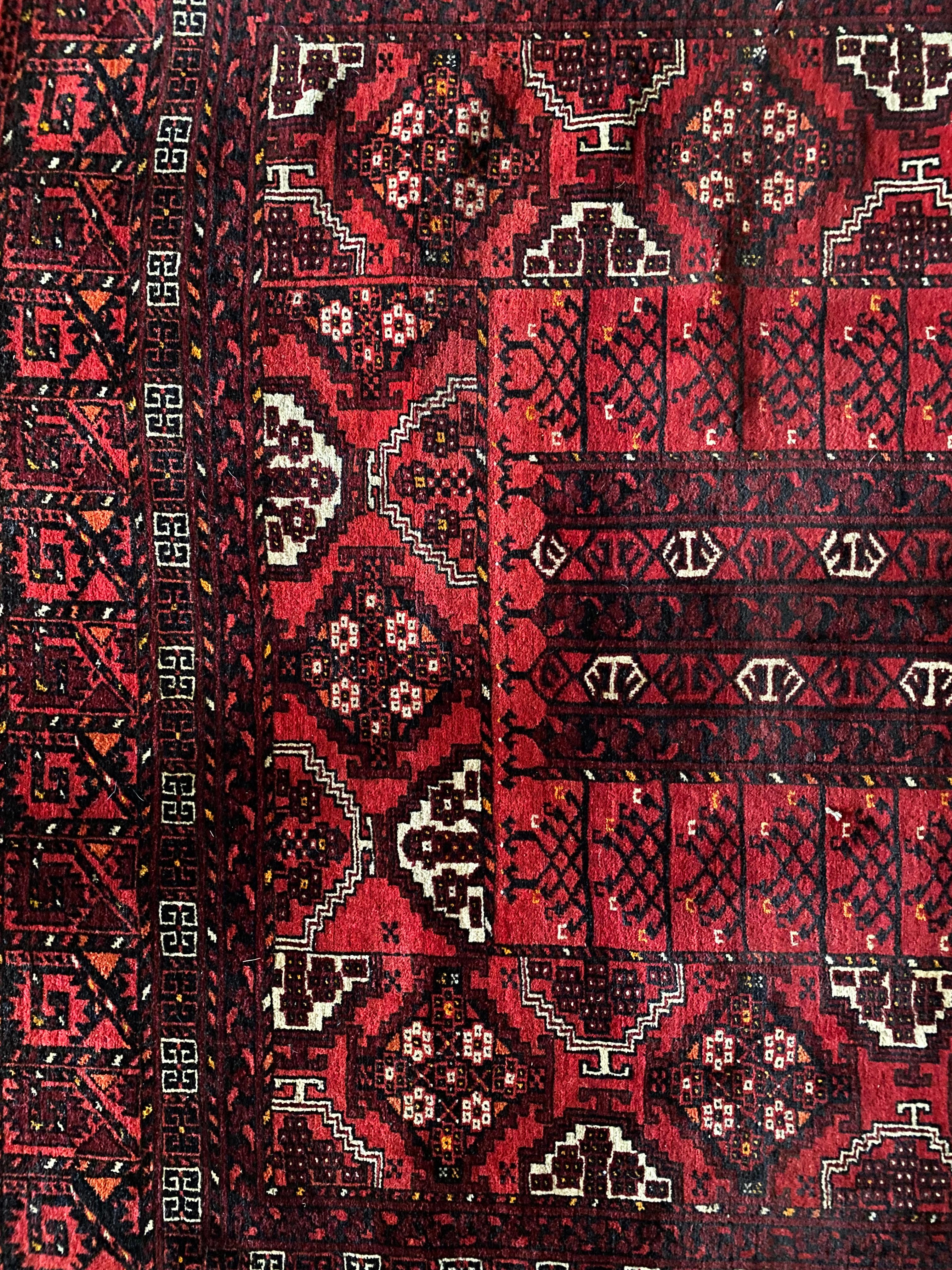 This Rug comes from the Turkmenistan Ersari Tribal group. It was originally used as the door of a tent it has a stunning pattern of a 'world tree' which depicts the upper and lower words of the Esari beliefs. It is crafted from soft pile wool that