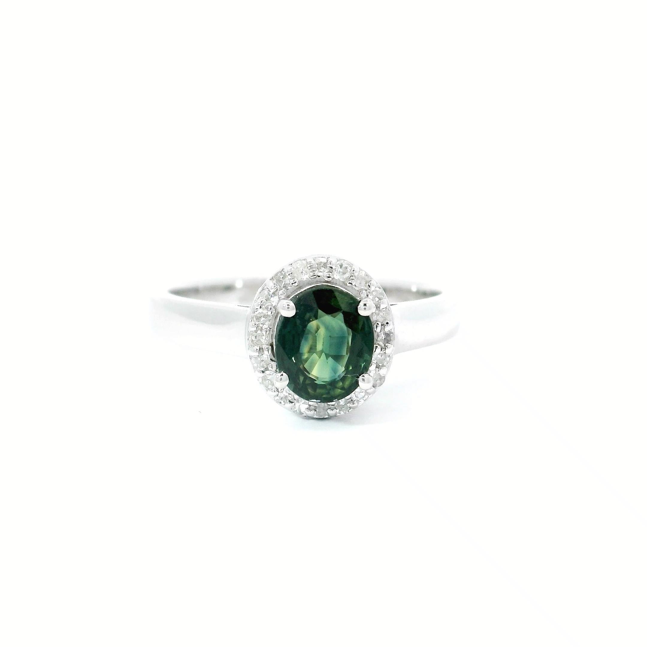 18kt white gold turmolive  Ring
  
  Gold colour & karat: White gold 18kt
  Weight: 3.91 grams
  
  Set with-
  Stone type: Turmolive 
  Shape: ovel 
  Carat: 0.87 cts
  Colour: Green Turmolive 
  
  Surrounding Stones: Diamonds
 1) White Diamonds
 