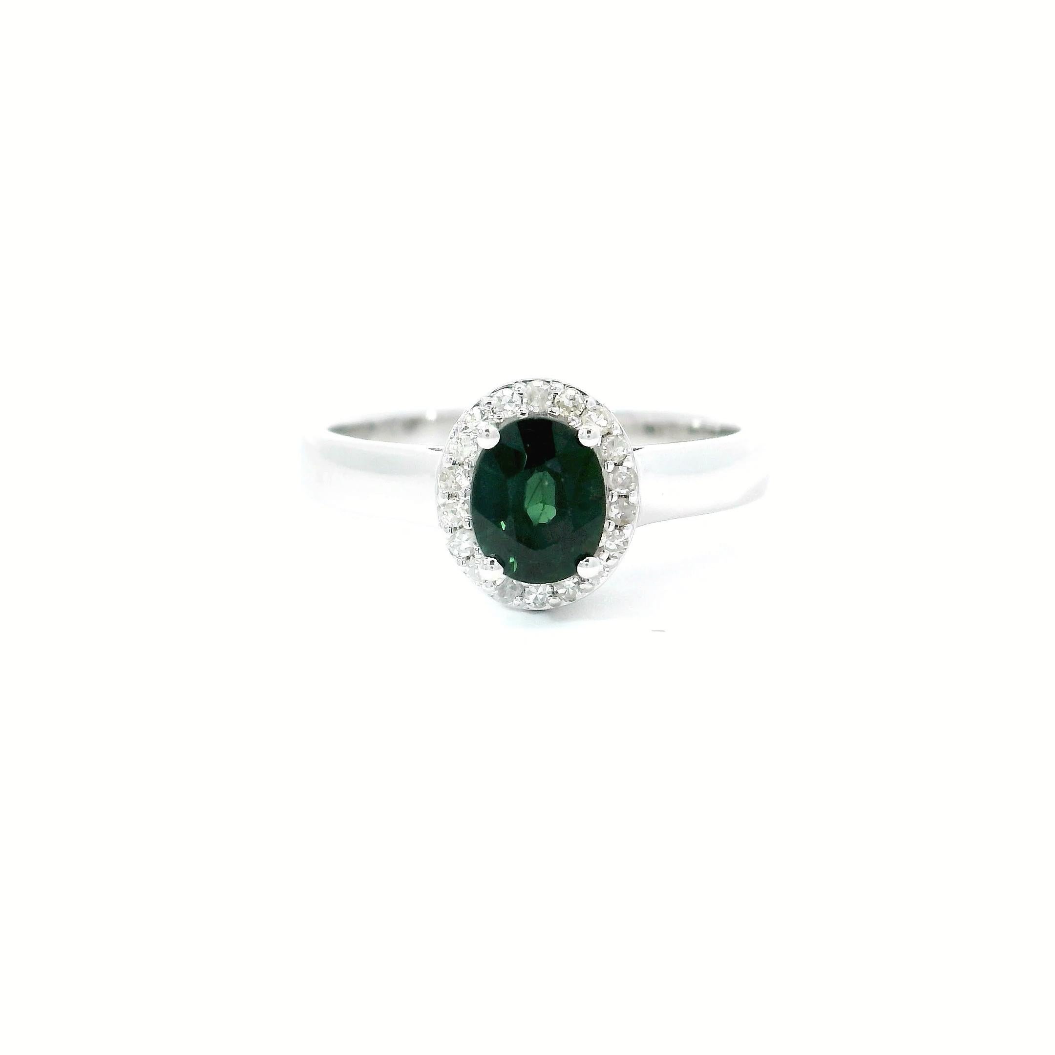 18kt white gold Sapphire Ring
  
  Gold colour & carat: White gold 18kt
  Weight: 3.79 grams
  
  Set with-
  Stone type: Diamond
  Shape: Oval 
  Carat: 0.79 cts
  Colour: Green Colour
  
  Surrounding Stones: Diamonds
 1) White Diamonds
  Carat