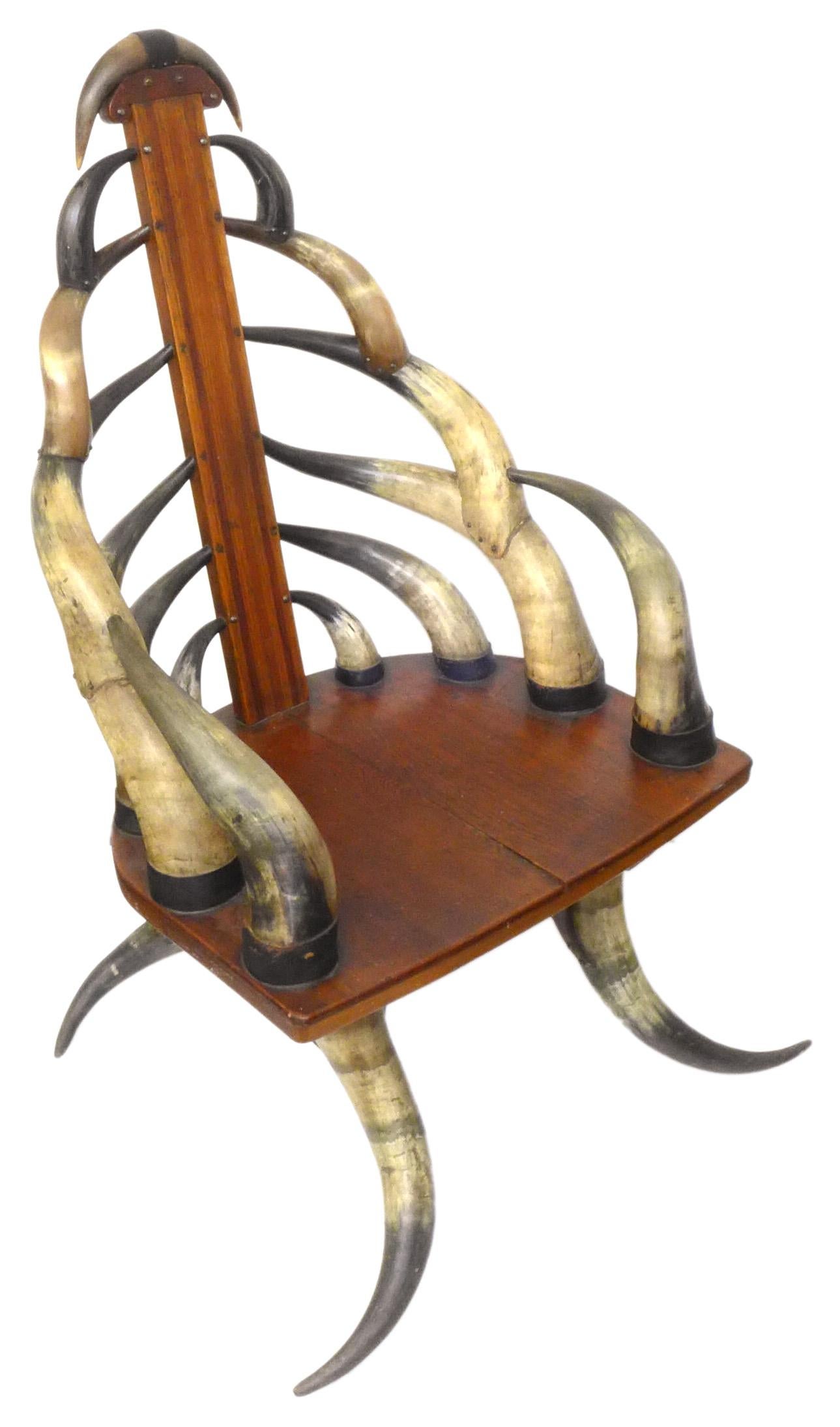 An outstanding turn-of-the-century steer-Horn armchair. A wonderful rendition of a notable niche in Americana decorative furniture; a beautifully symmetrical edifice of over two dozen variously-sized, artfully-joined steer horns with laminated-wood