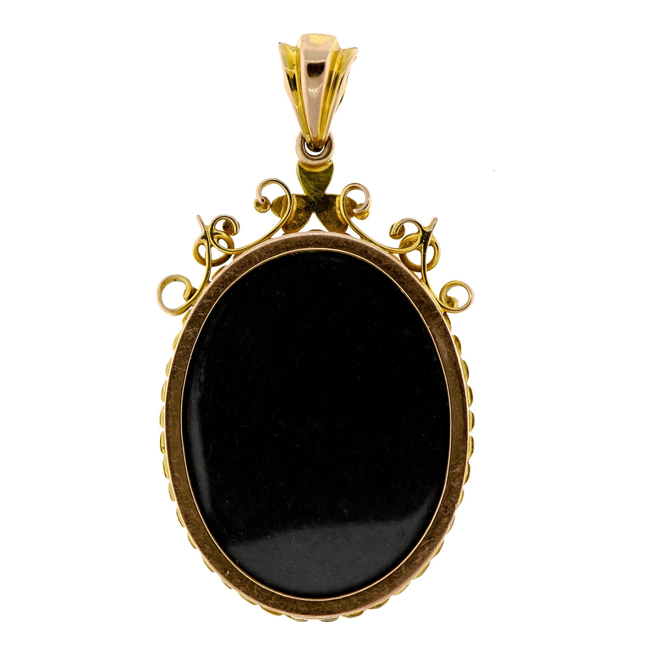 Turn-of-the-Century antique enamel and pearl miniature locket containing one (1) oval French enamel locket of a Woman in Profile set into an ornate pearl and yellow gold frame, glazed locket back.