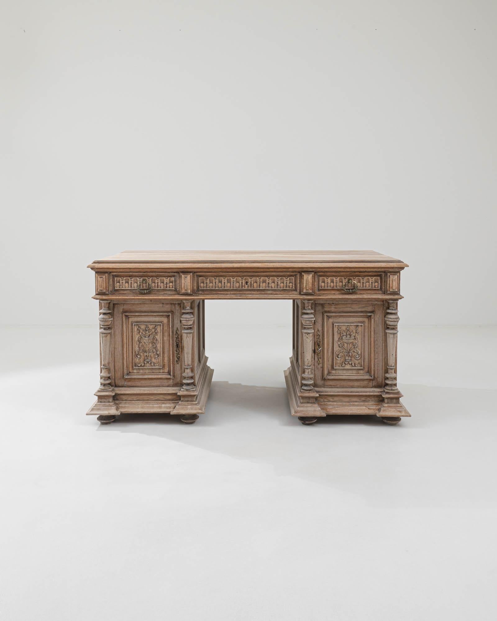 This Neo-Renaissance oak writing desk has a timeless air of magnificence. Built in Belgium at the turn of the century, the aesthetic harks back to the solid, ornate furniture of Renaissance palaces and villas — while the stationary drawers and