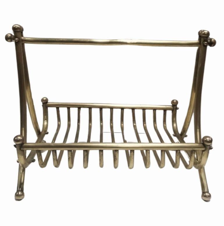 Introducing our Vintage Newspaper Rack from the 1910s, a stunning piece crafted from gilded tubular design. Could also be used as a fireplace wood holder. With its sleek lines and elegant design, this rack effortlessly captures the essence of