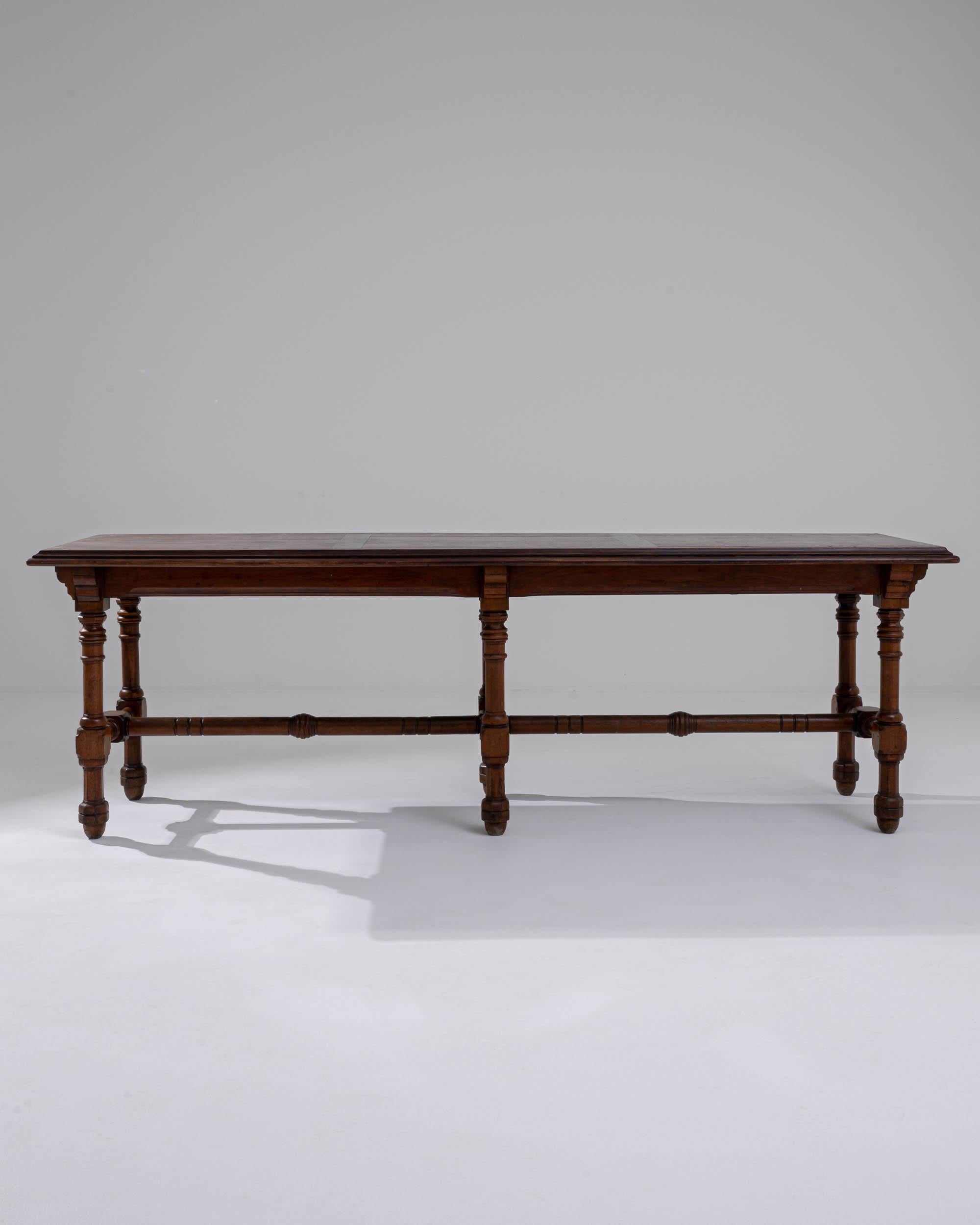 A rich original patina gives this vintage table a distinguished air. Made in Great Britain at the turn of the century, the design reflects the handsome, heavy furniture of the Victorian age. Architectural details — such as the contoured brackets