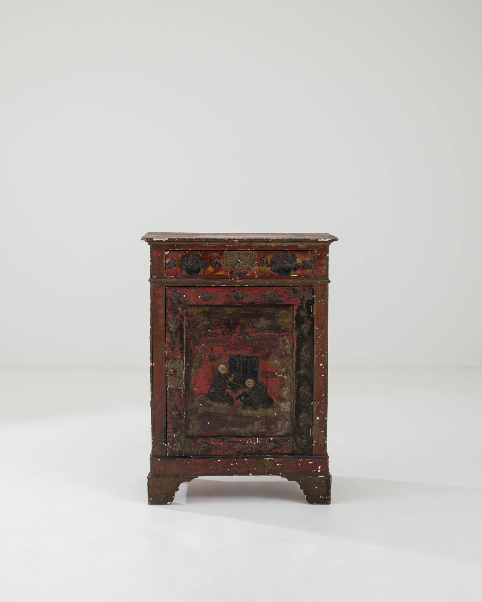 A weathered patina gives this vintage wooden buffet an air of romantic mystery. Built in China at the turn of the century, the cabinet is richly decorated with motifs of flowers and traditional scenes from Chinese paintings. The years have worn the