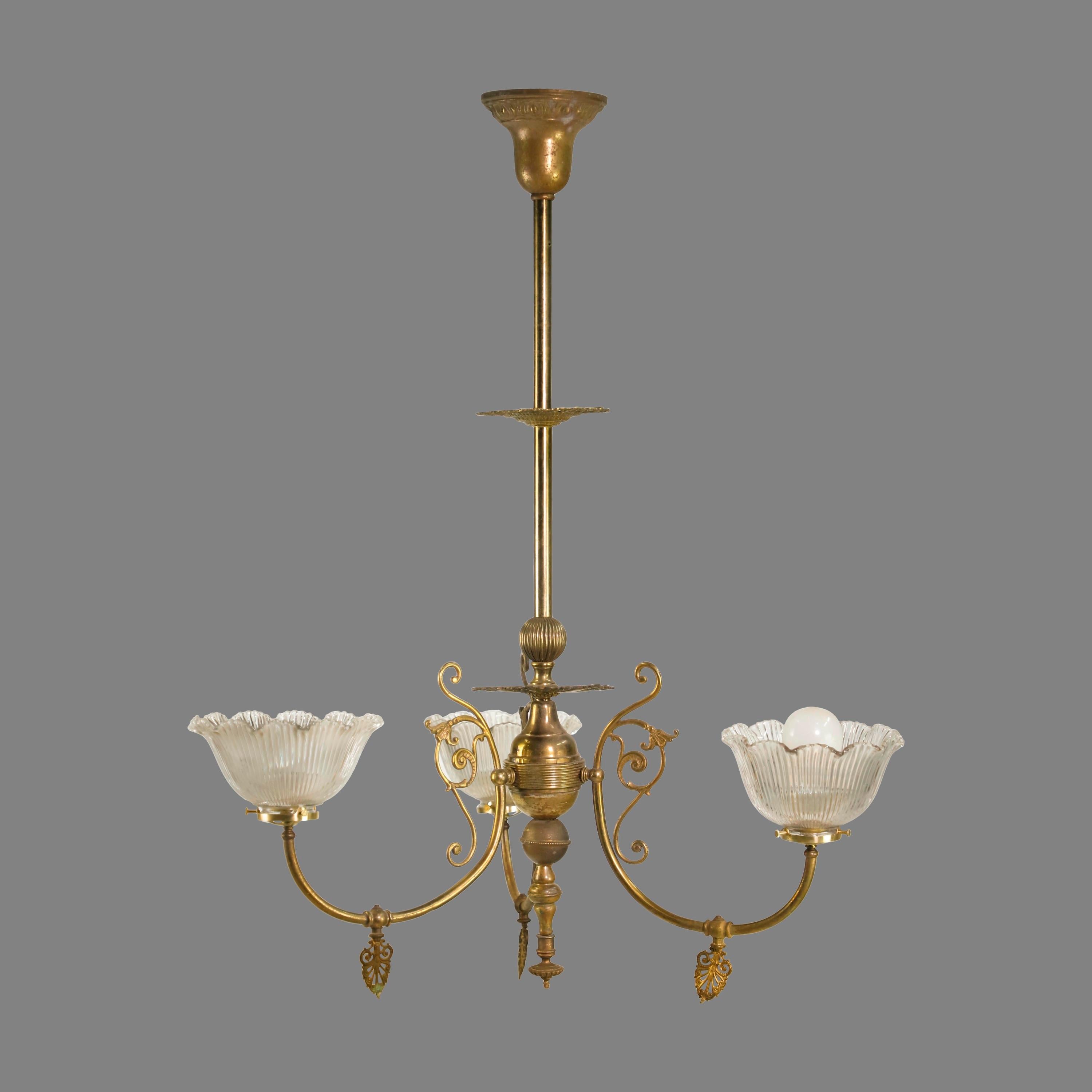 Turn of the century 3 arm chandelier. Made from brass. This light originally was powered by glass and has been converted to electric. Original period shades. Cleaned and restored. Please note, this item is located in our Scranton, PA location.