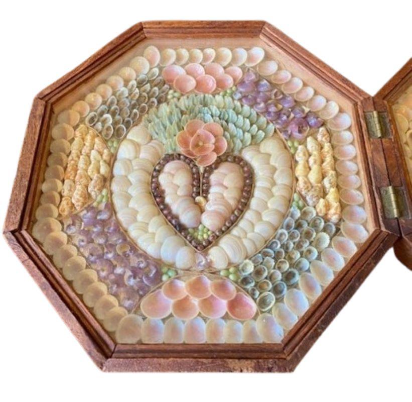 Antique Double Sailor's Valentine, dated 1903, a pair of handcrafted shell collages mounted in mahogany octagonal shadowboxes, hinged together and mounted with a clasp. This valentine features a heart and the inscription 