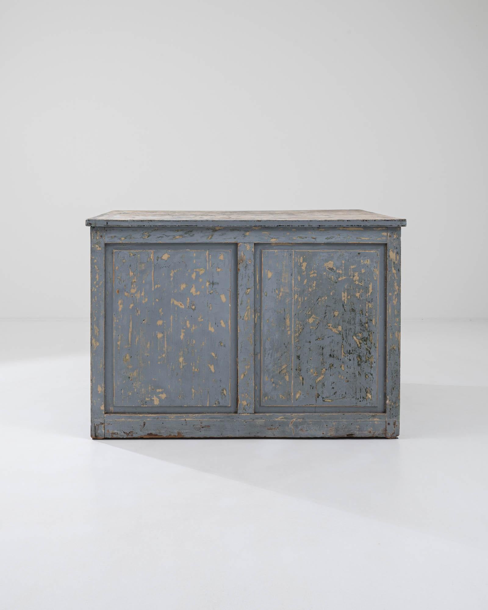 A nostalgic patina gives this Industrial flat file cabinet a one-of-a-kind personality. Built in France at the turn of the century, the spacious cabinet houses an array of long, slender drawers — a shape which indicates that this piece was likely
