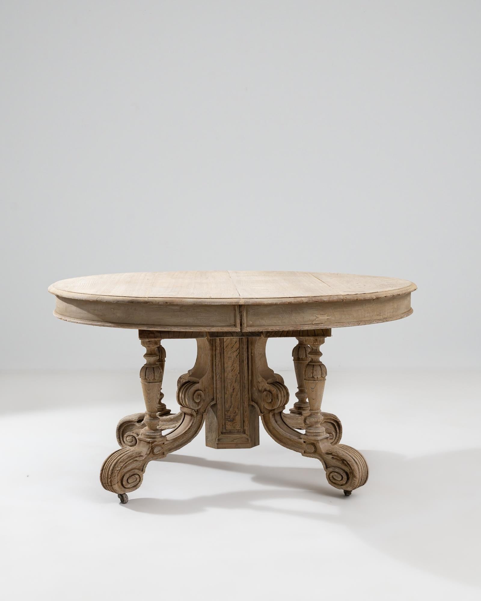 Ornate yet organic, this vintage table combines Baroque extravagance with a soothing natural finish. Hand-made in France at the turn of the century, a simple circular tabletop rests atop an elaborate carved base. The legs are composed of sinuous