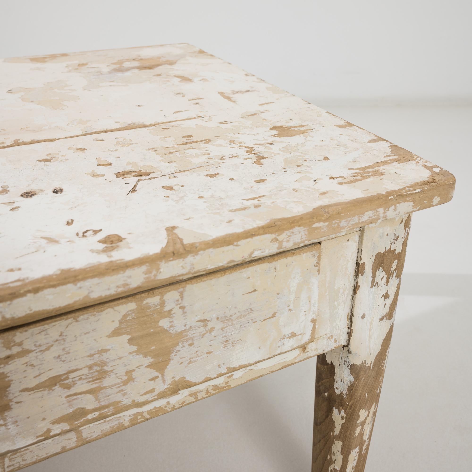 This delightful coffee table was produced in France, circa 1900. A large wooden coffee table in a rich chiffon white, provided with two practical large drawers garnished with metal cup pulls. Richly distressed, the organic patina offers a peek of
