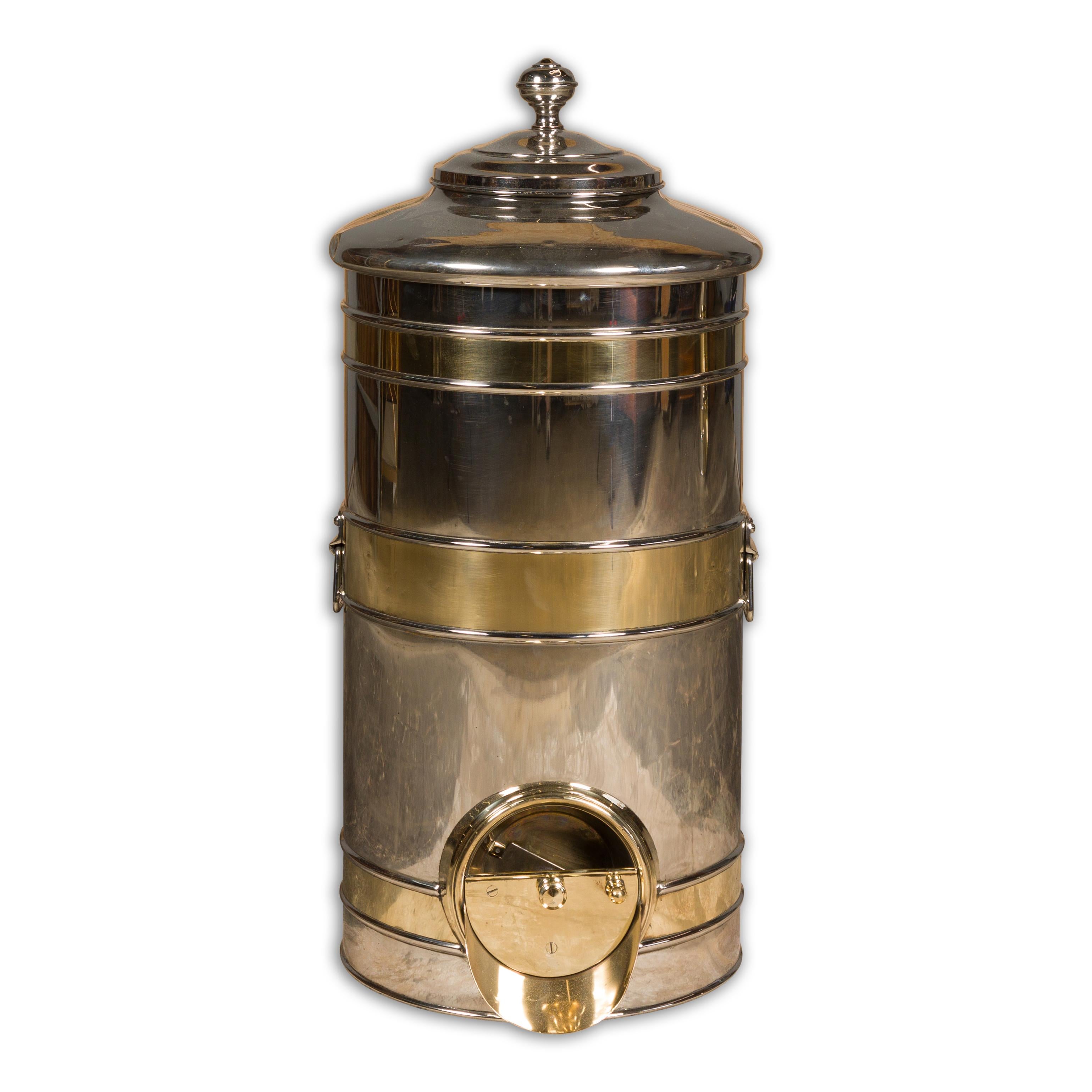 A French 1900s steel and brass coffee bean dispenser from the Turn of the Century. This French Turn of the Century coffee bean dispenser, crafted from steel and brass, is a captivating blend of vintage charm and functional elegance. Dating back to