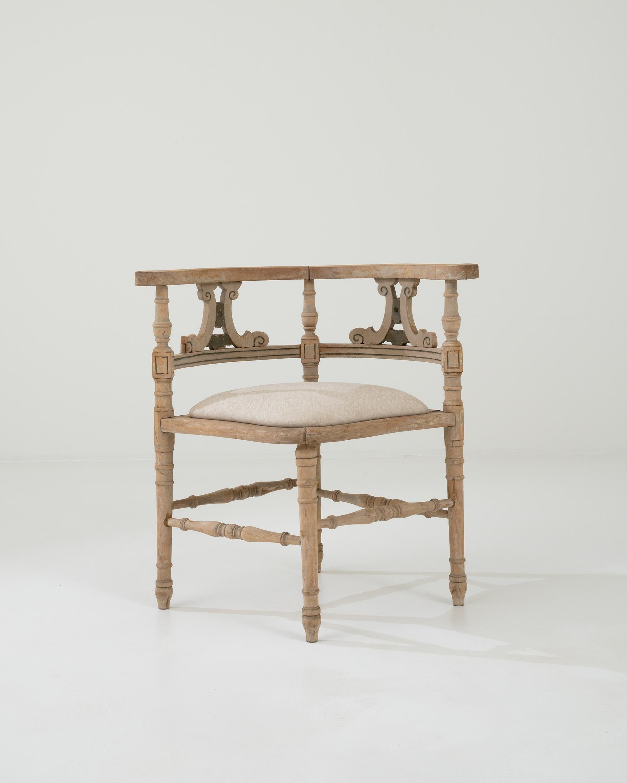 The intriguing shape and soothing natural finish of this carved oak corner chair makes it a vintage find to treasure. Built in France at the turn of the century, the seat is arranged in a diamond formation, with one corner at the front, and an