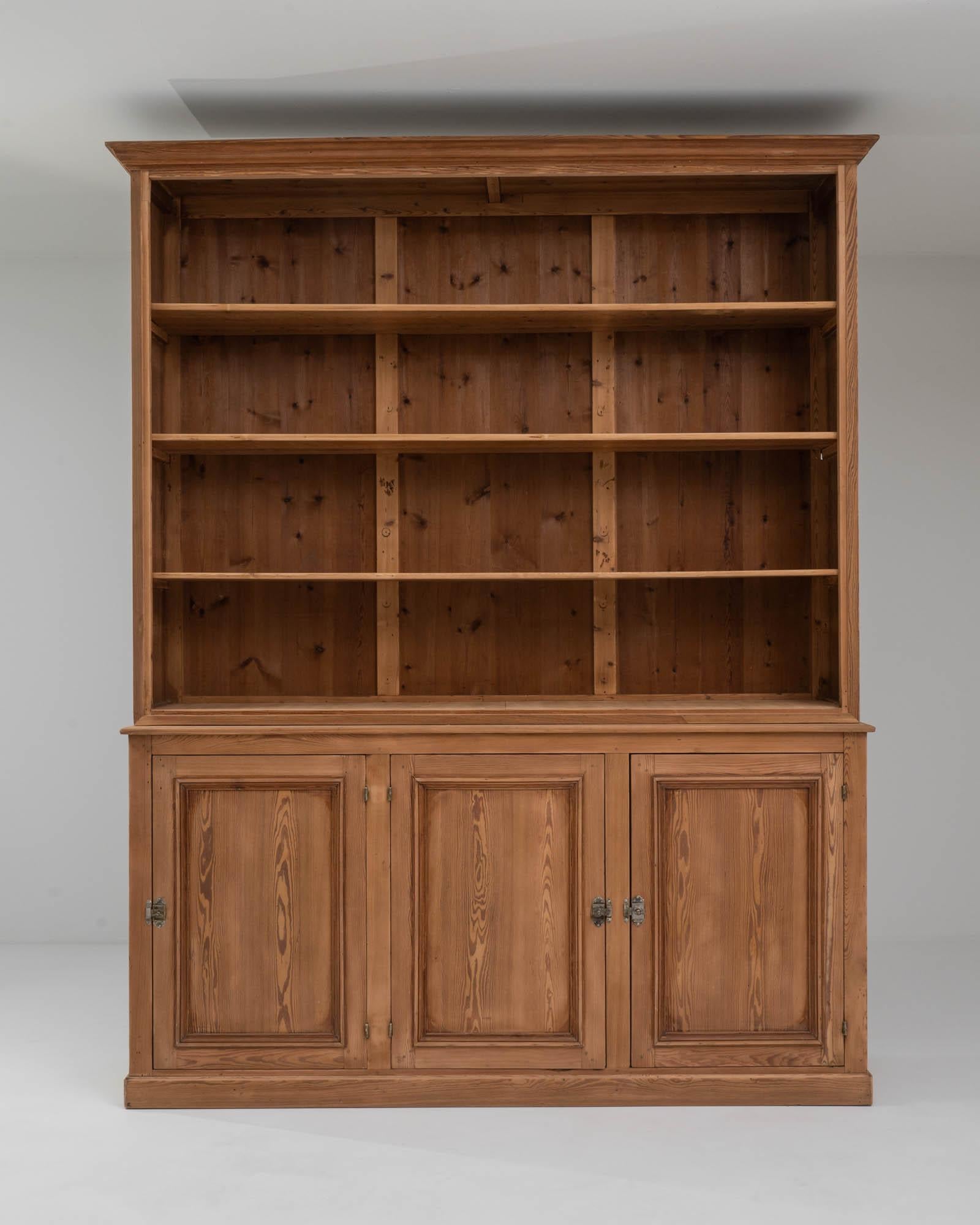 This pair of vintage wooden library cabinets would make a distinguished addition to a book-lined office or personal study. Made in France at the turn of the century, the cabinets are tall and broad: long shelves provide plenty of room for organizing