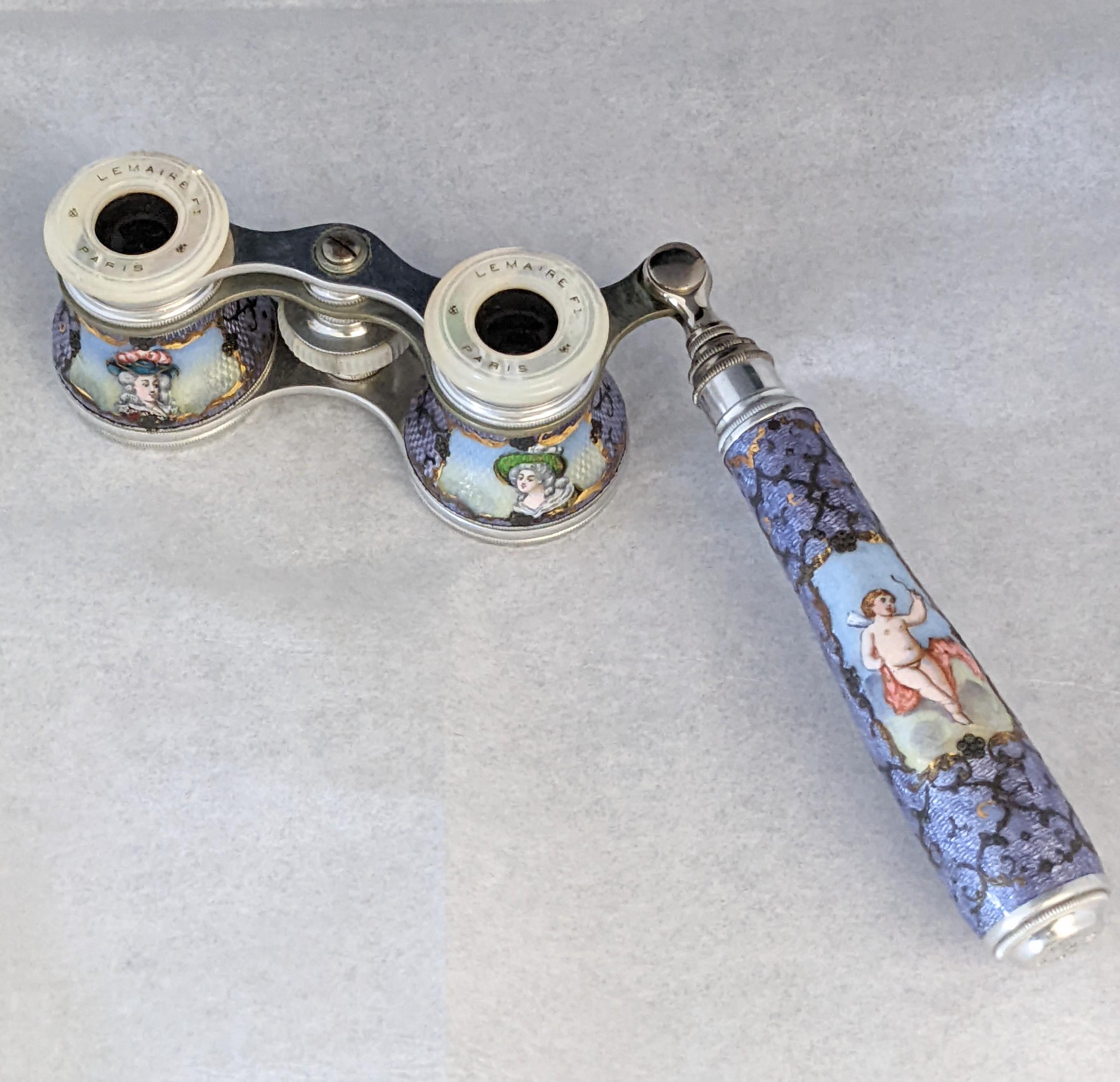 Lemaire Enamel Opera Glasses made in Paris circa 1930's with hand enamel painted 18th Century figures with a cupid on handle. Extremely beautifully painted on a lavender base with gold highlights. Eye pieces in Mother of Pearl with the Lemaire,