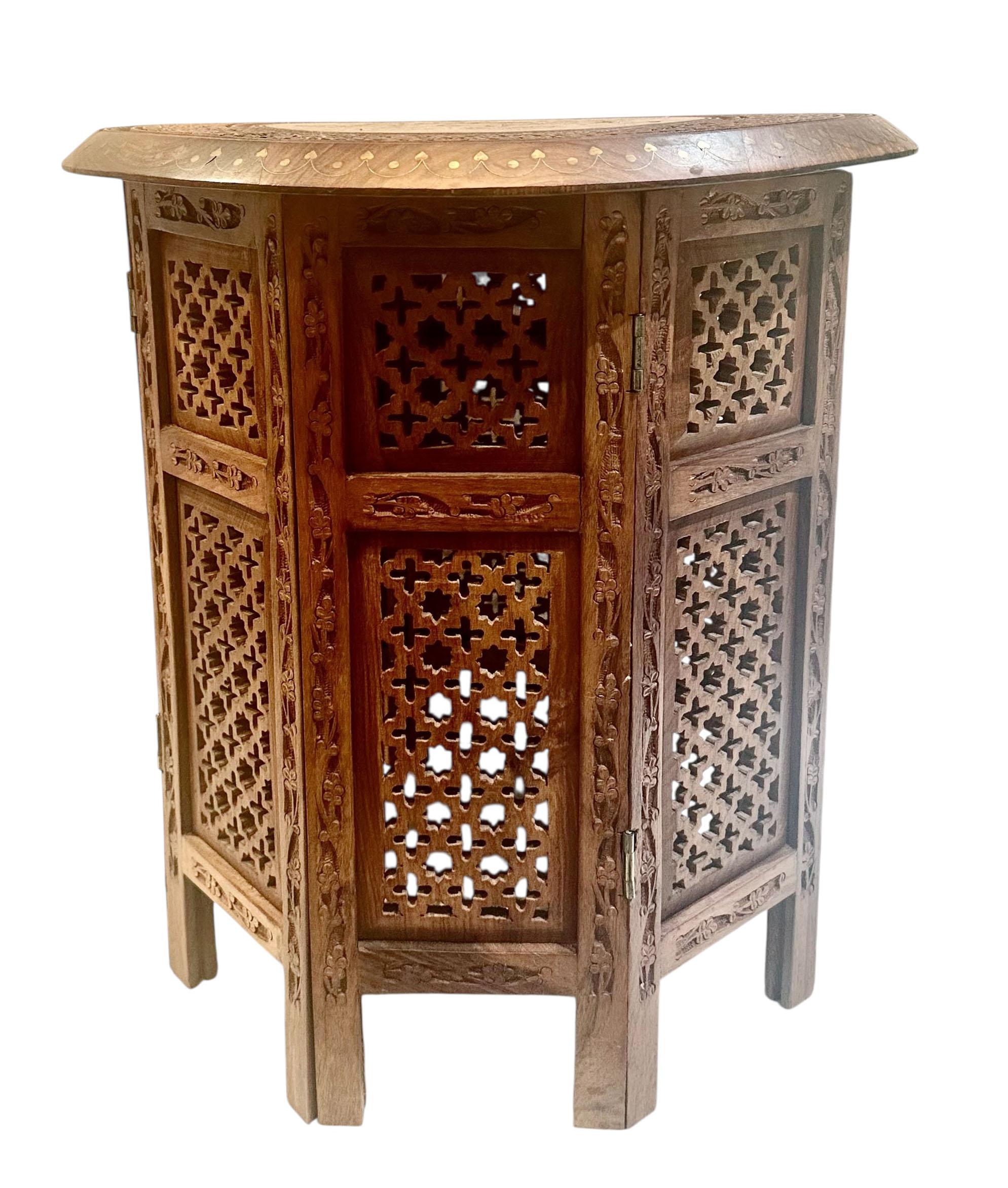A richly detailed ottoman style side table, dating to the turn of the century, circa 1900–1915 . This extraordinary piece features eighteen carved panels, each adorned with intricate vines and floral motifs. The carving is complemented by elaborate