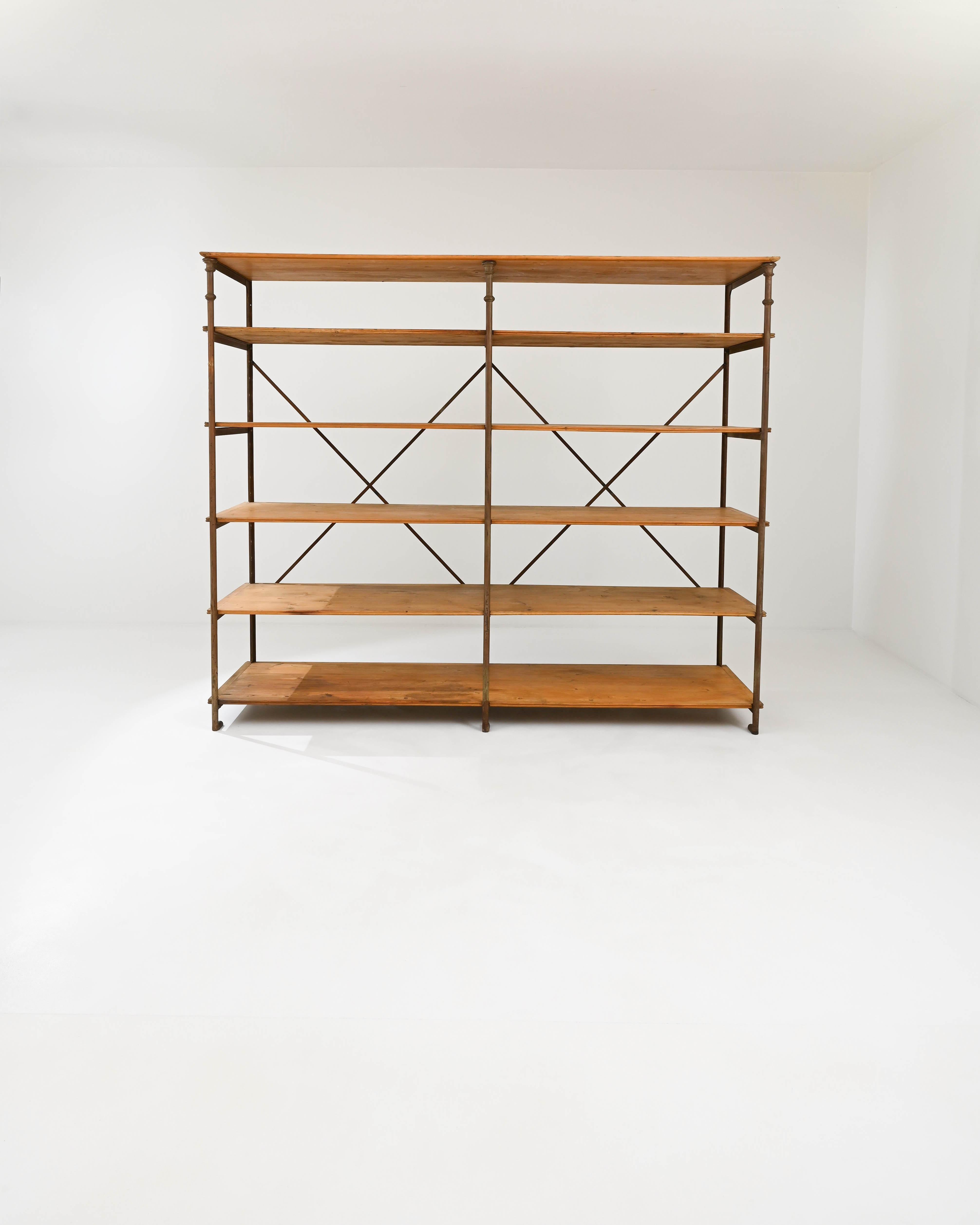 Combining rationality and grace, this vintage shelving unit is a classic of Industrial design. Built in Paris at the turn of the century by Theodore Scherf — an embossed plaque on the frame attests to the piece’s authenticity — the grid-like form is