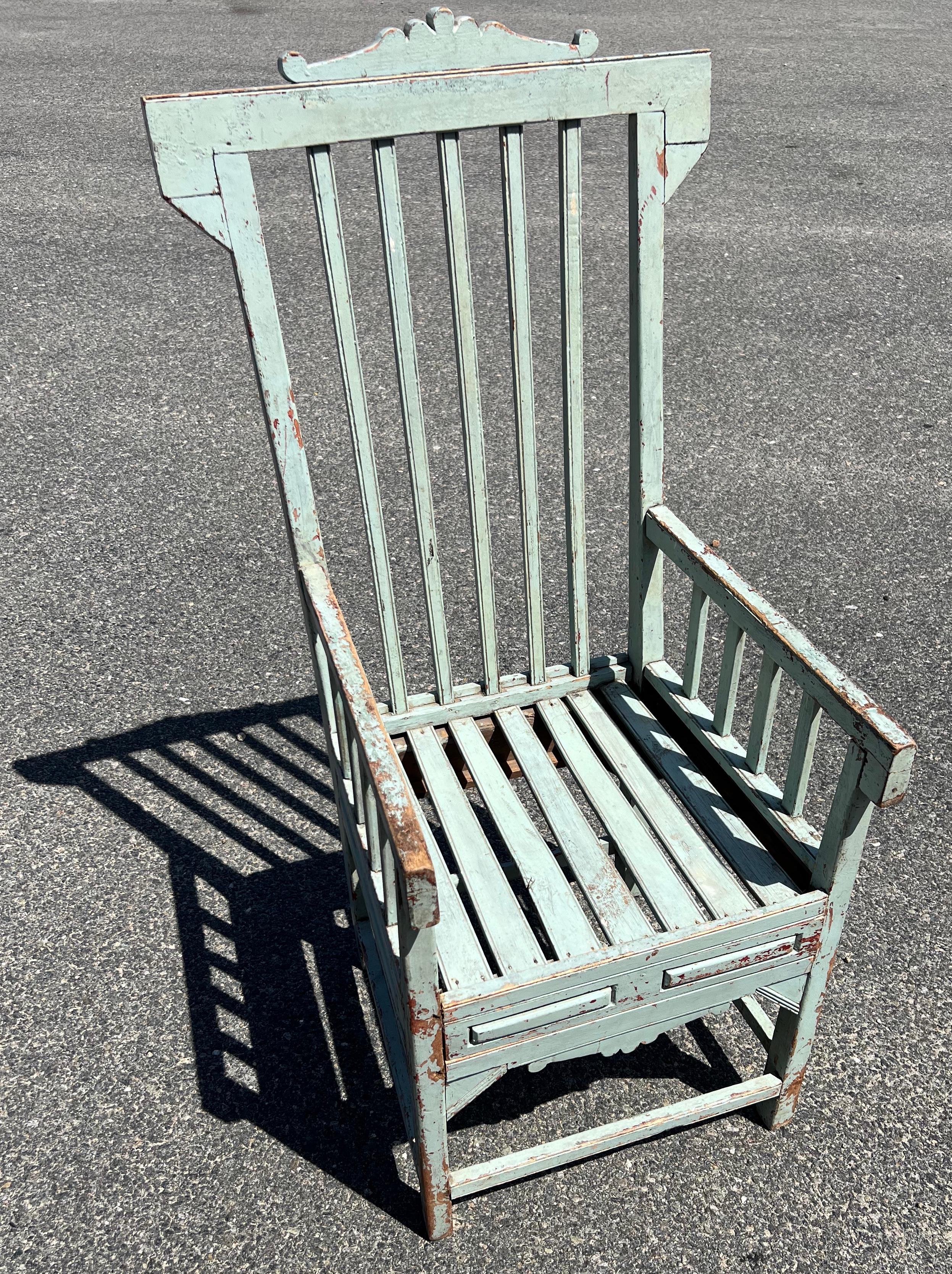 Slatted Eastlake-style arm chair with detailed apron in original pale blue/green over red paint.