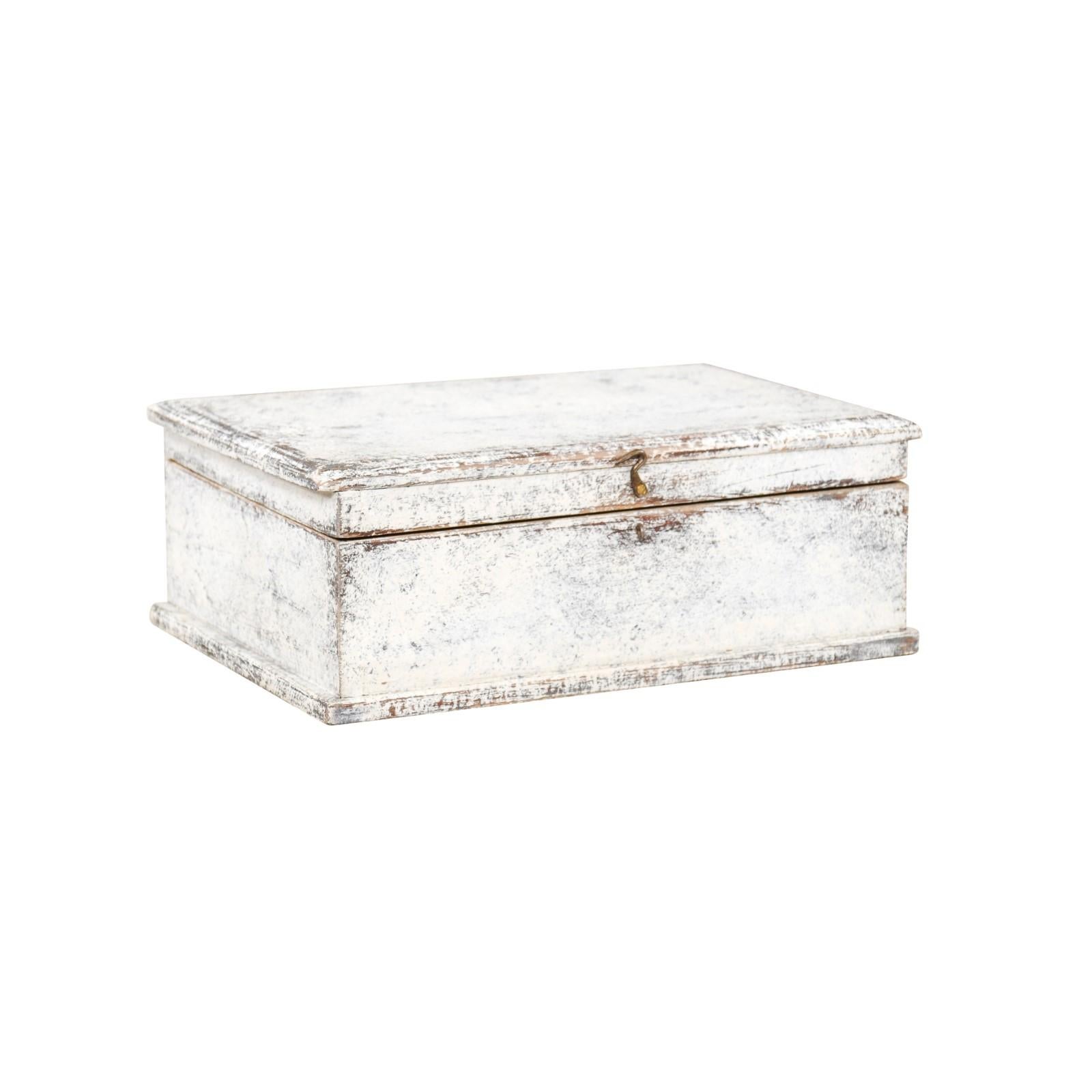 A Swedish Turn of the Century Period painted wood box from the early 20th century, with brass hook, distressed finish and natural interior. Created in Sweden at the Turn of the Century which saw the transition between the 19th to the 20th, this