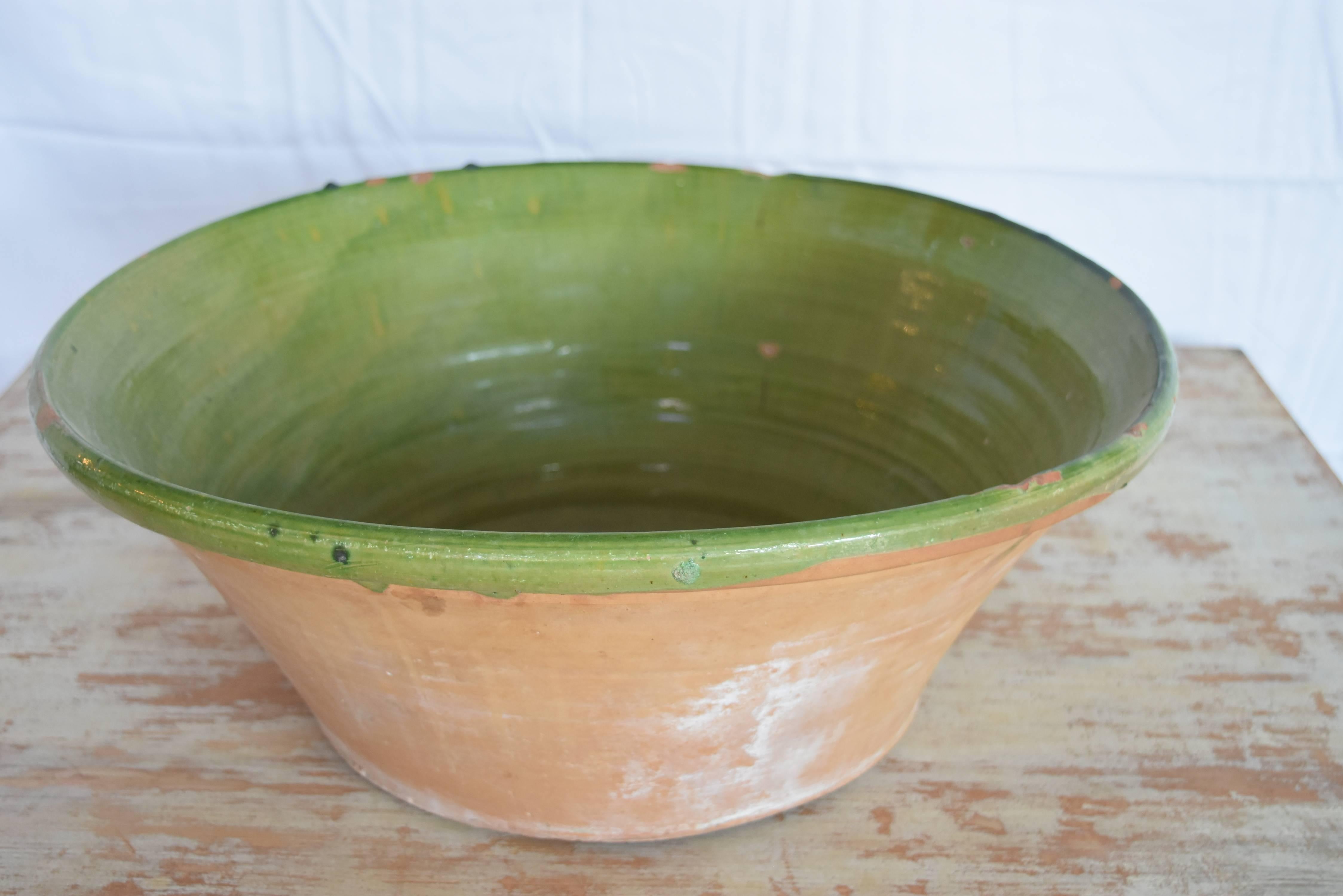 This is a pretty green color terracotta bowl that originated in the Catalonia region of Spain. It shows a few minor chips but is in very good condition.