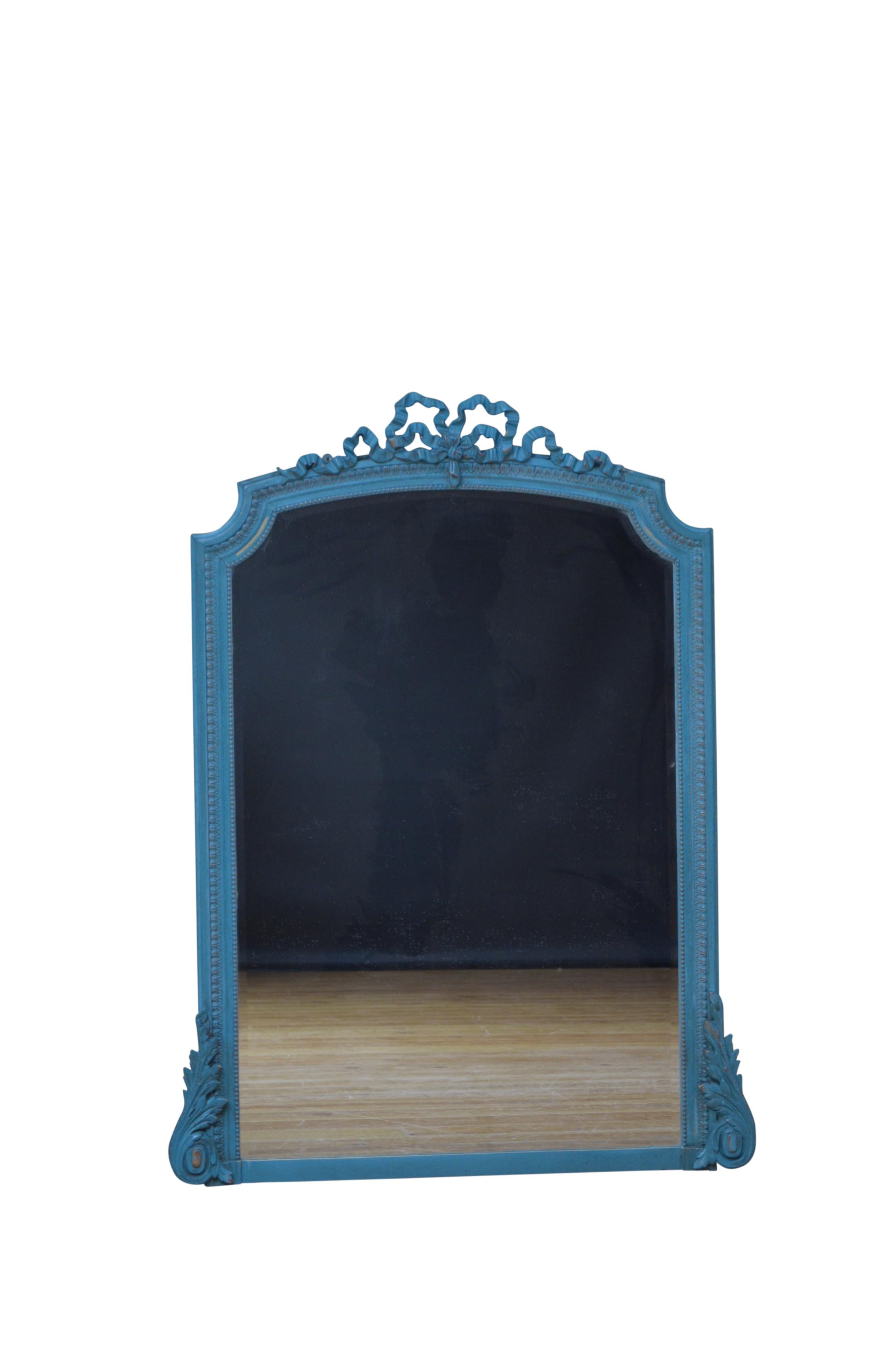 Very attractive turn of the century teal / blue painted overmantel mirror, having original bevelled edge glass with some imperfections in moulded and beaded frame with ribbon crest, flanked by fine leafy scrolls to the base. This antique mirror