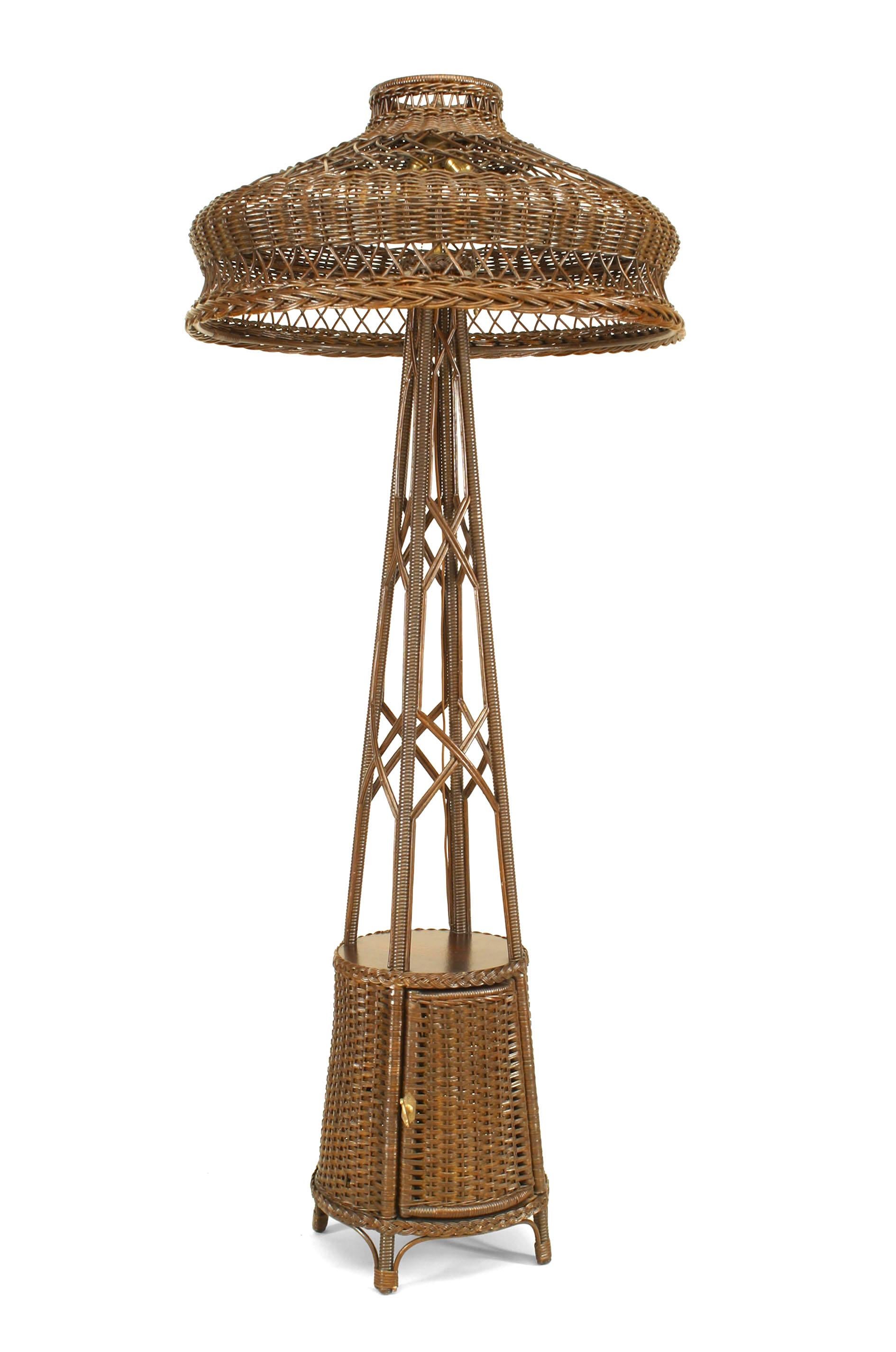 Turn of the century American Mission style floor lamp composed of dark stained wicker with a broad domed shade above a simple intersecting shaft and conical cabinet base.