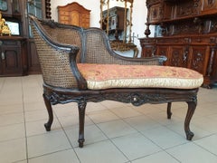 Turn of the 19th-20th Century Dark Wood Chaise Lounge Finished with Rattan