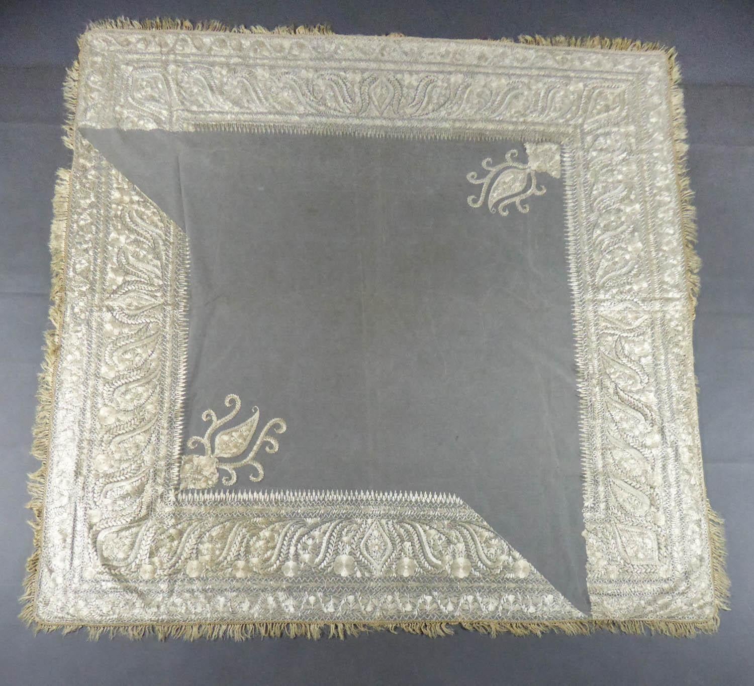 Circa 1840
India for fashion in Europe

Square turn-over shawl in cotton tulle embroidered in Delhi in the mid-nineteenth century and exported for fashion in Europe. Background in very fine cream cotton tulle embroidered with silver cream floss-silk