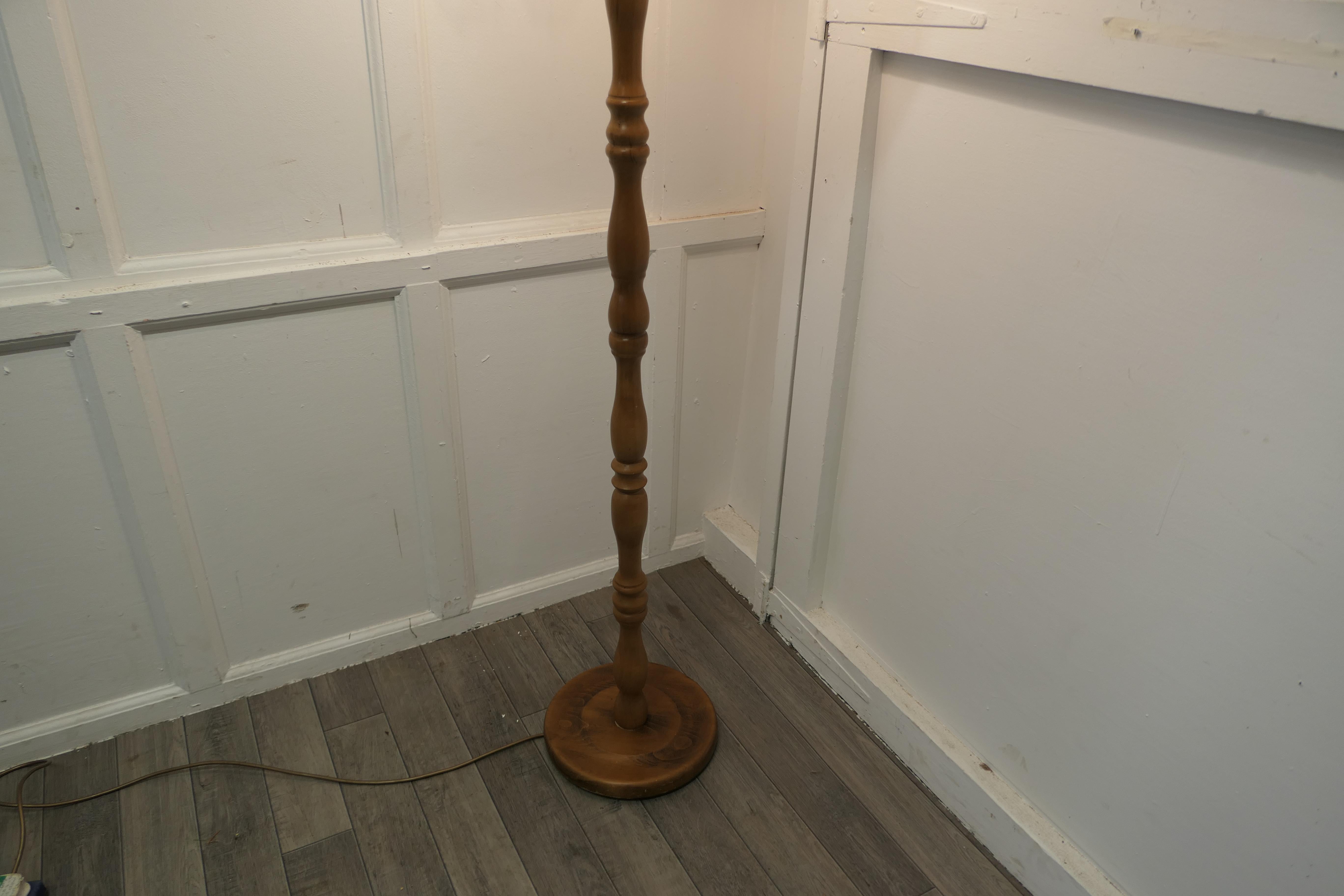 Turned beech floor standing lamp

A skilfully turned piece, this lamp stands on a turned wooden base, it is in good condition, the wiring seems to be new and is working
The lamp comes with an oval shade, this can be included if requested at the