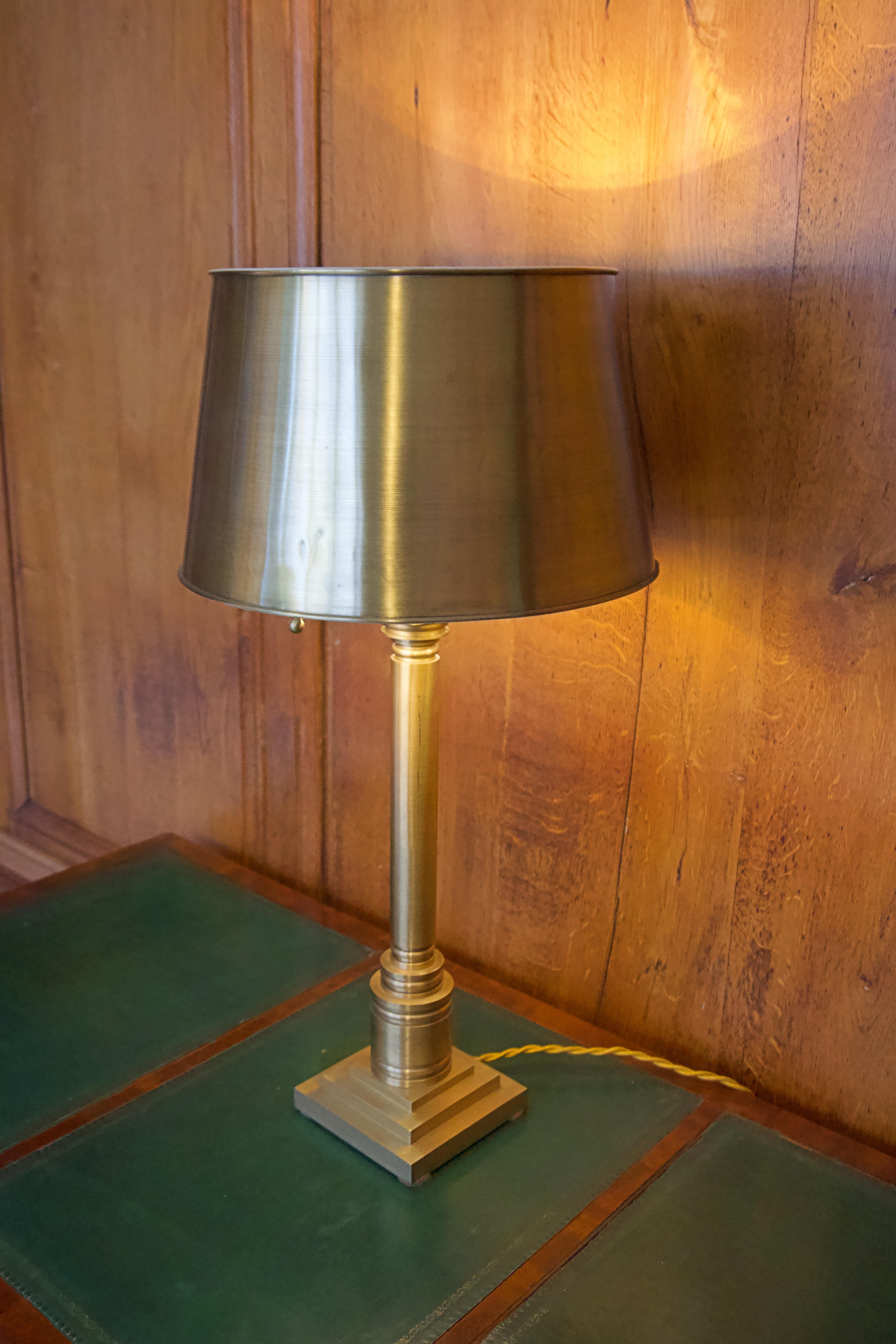 Brass lamp, new wiring (gold braided cord and brown switch),
having a solid brass base, turned brass stem and elements
with a brass shade with painted interior. All brass sealed against tarnish.