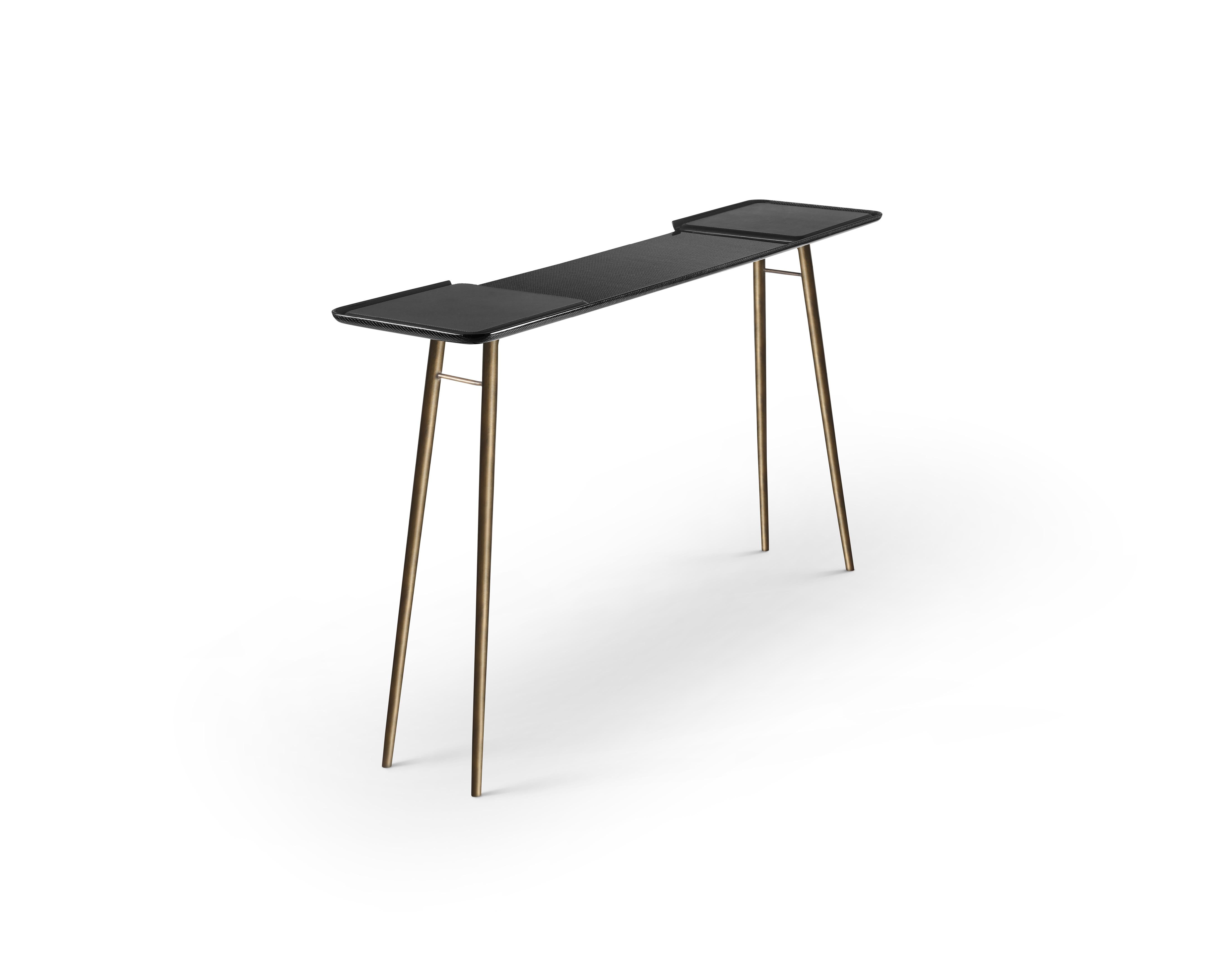 Turned carbon fibre talon console by Madheke.
Dimensions: W 153.5 x D 36.3 x H 88 cm.
Materials: Leather, carbon fibre, cast brass legs.

The Talon's signature black aesthetic makes this console table an understated vision. The striking clean