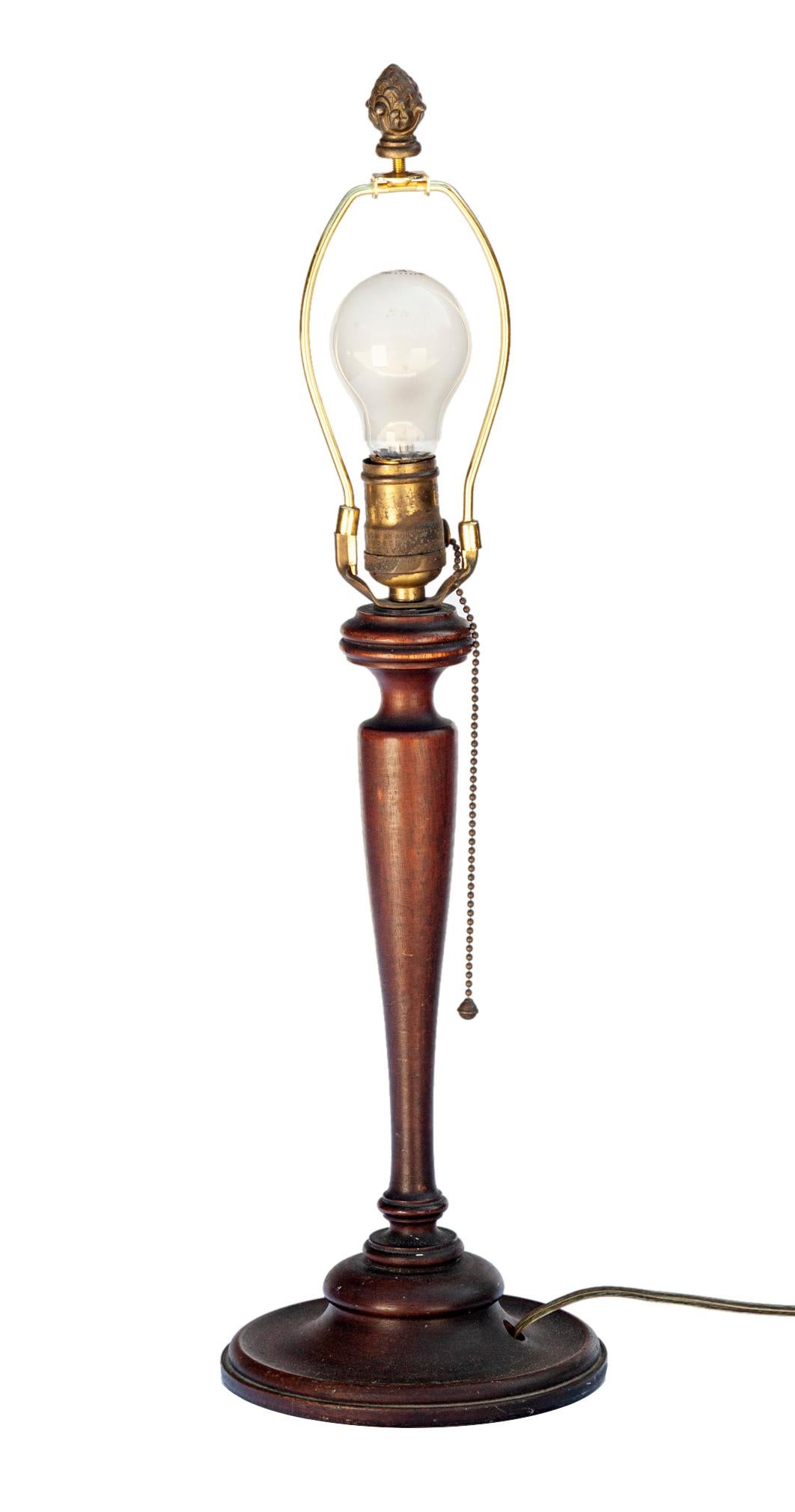Vintage hand turned wood spool lamp. A table lamp in finely turned walnut with original finish. Original extra long brass pull chain, new silk shade by RH.
Designed and produced by an unknown studio craftsman.
Beautiful patina to the wood and brass.