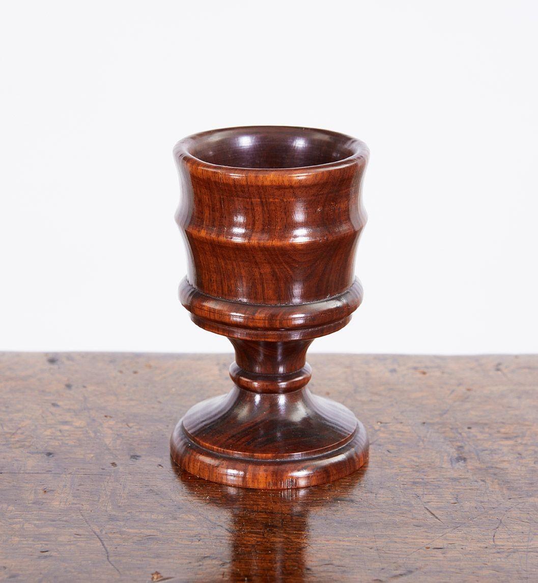 Early 19th Century English turned kingwood small vessel, perhaps a rum cup egg holder, having banded sides, the whole with rich patination.
Treen