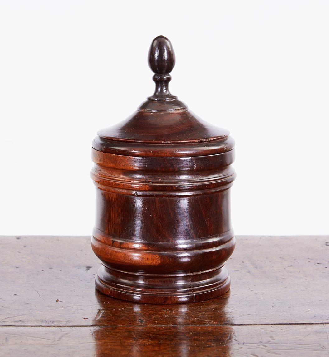 Good early 19th Century turned Lignum Vitae tobacco jar, the stepped lid with acorn finial, over cylindrical ring turned body, the whole with good rich color and striking contrast with heart and sap wood, so prized among treen collectors.
treen