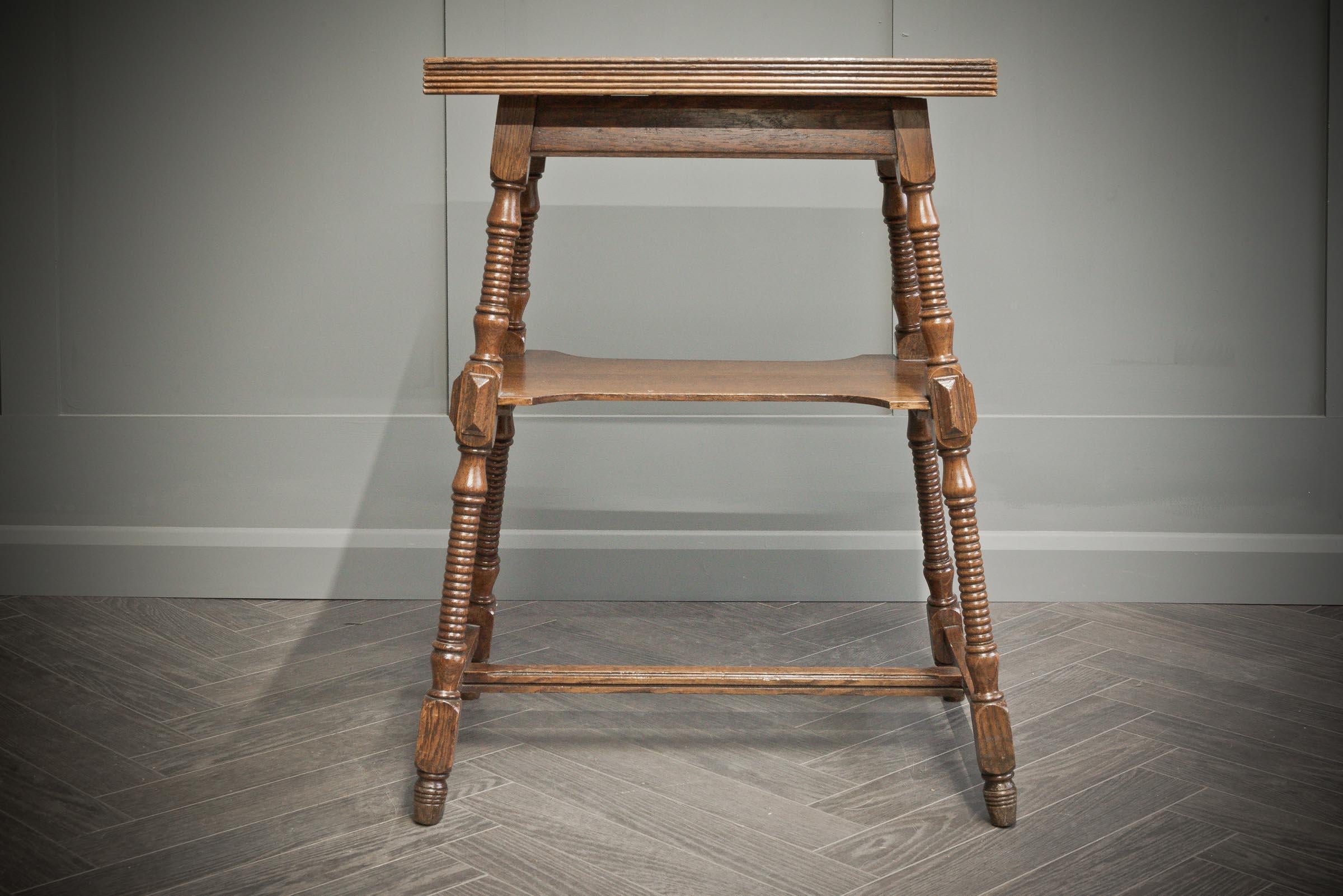 One of a kind metamorphic swivel top oak table with dark and light grains running through the wood. The table top swivels to reveal a storage compartment underneath. The table has four beautifully detailed legs with textured carvings. 