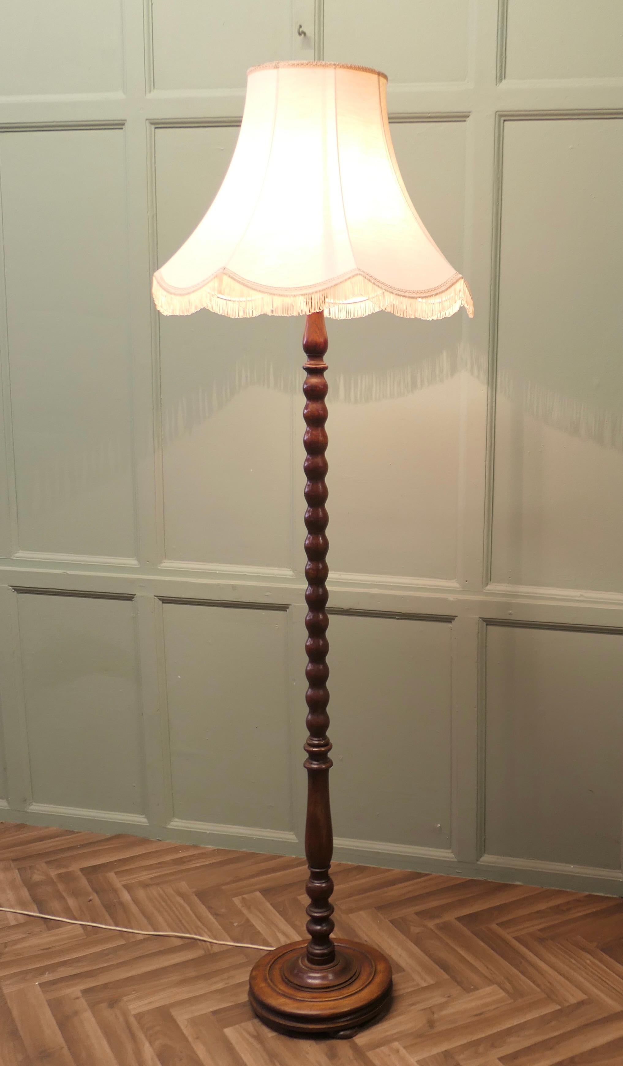 Turned Oak Floor Lamp, Standard Lamp

The turned central column has a chunky bobbin turned wooden base, it is in good condition, the wiring is good, this is a very fine quality lamp and comes with an attractive  lampshade
The lamp is 72” high and