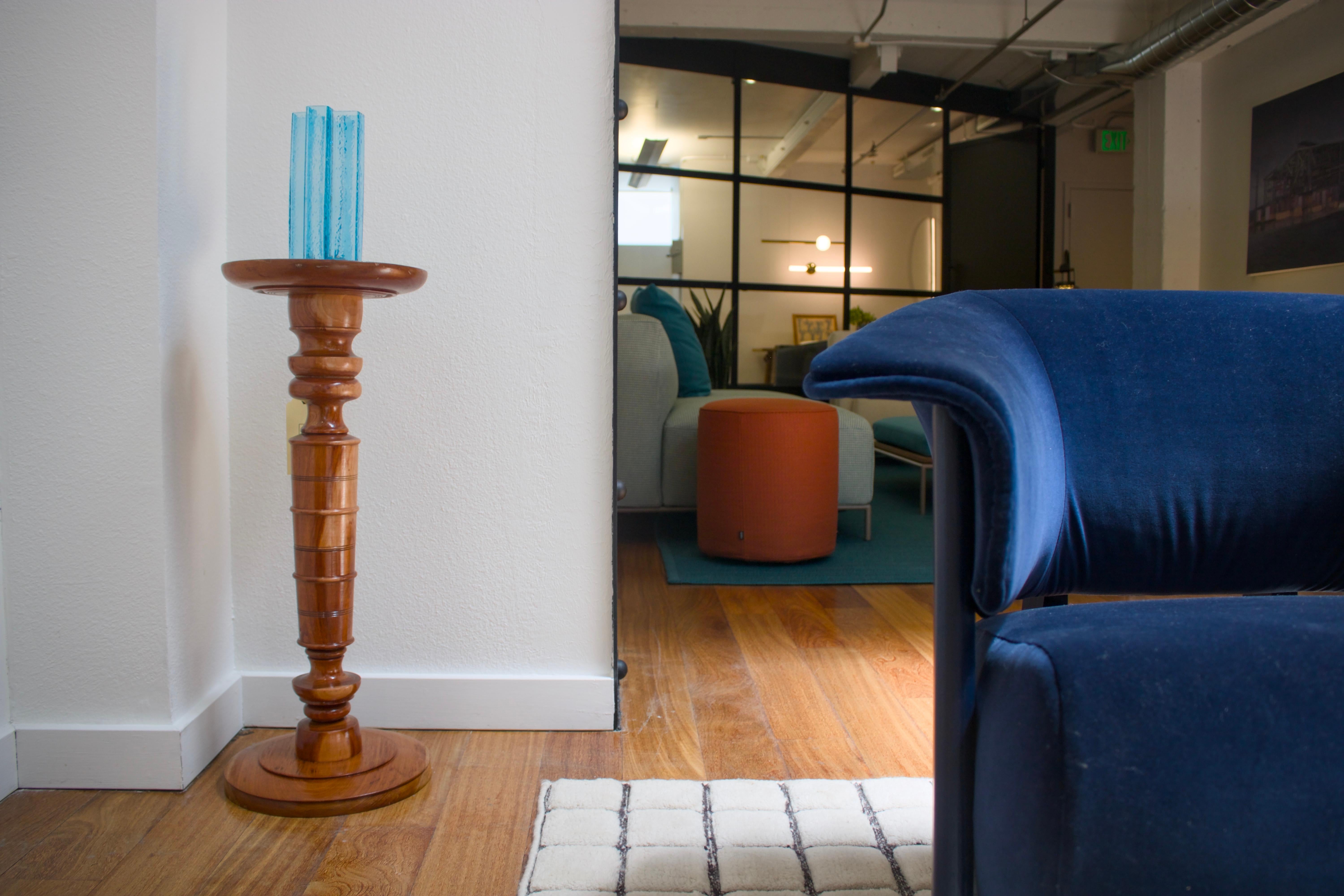 A turned solid oak pedestal/side table/candle holder, measuring just below 12” in diameter.
