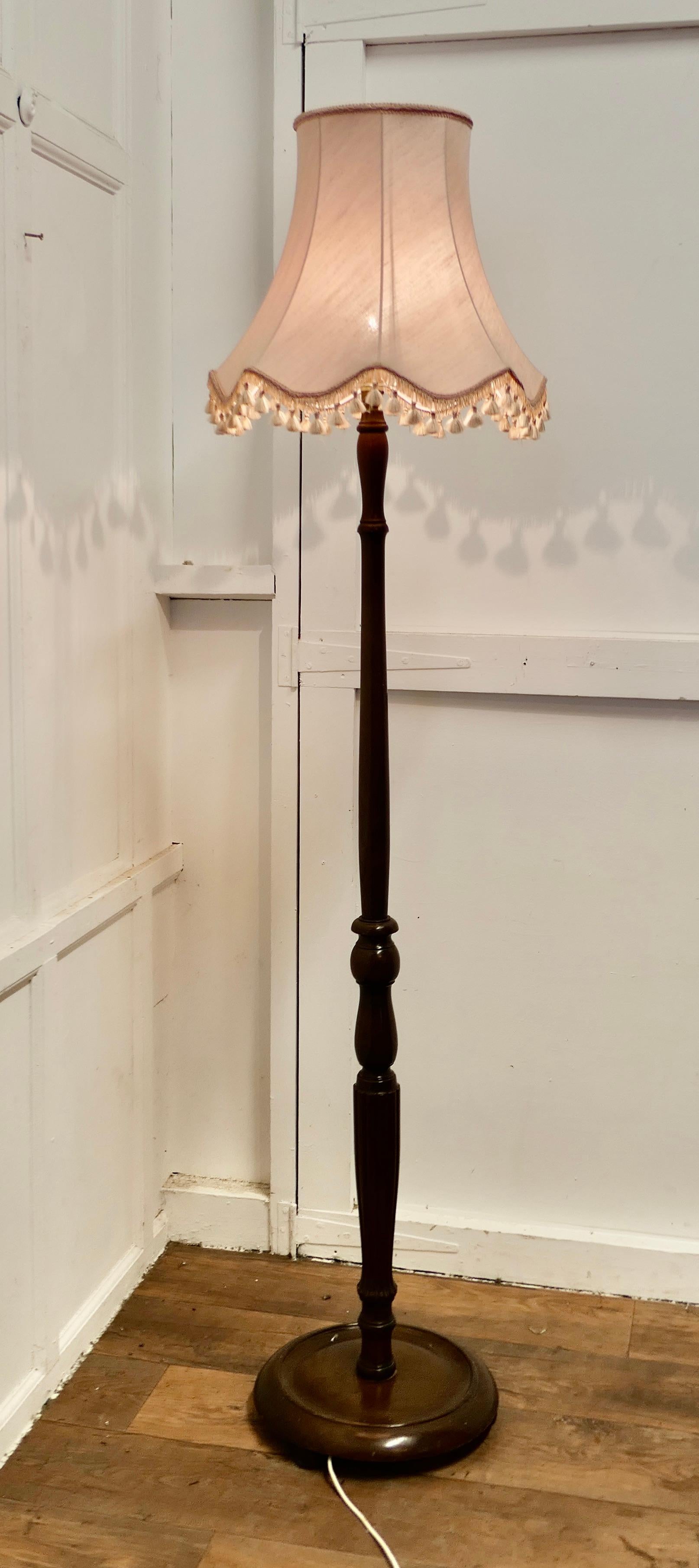 Turned Walnut Floor Lamp, Standard Lamp

 An attractive piece in walnut, this lamp stands on a turned wooden base, it is in good condition, the wiring is good, this is a good quality lamp
The lamp is 73” high to top of the shade with is 19” in