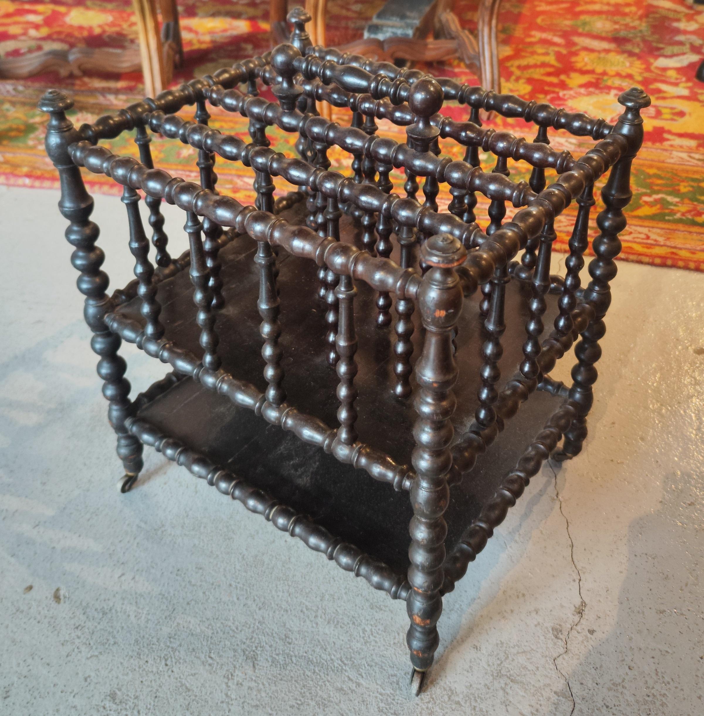 20th Century Turned Wood Magazine Rack with Brass Wheels and Handle in the Centre For Sale