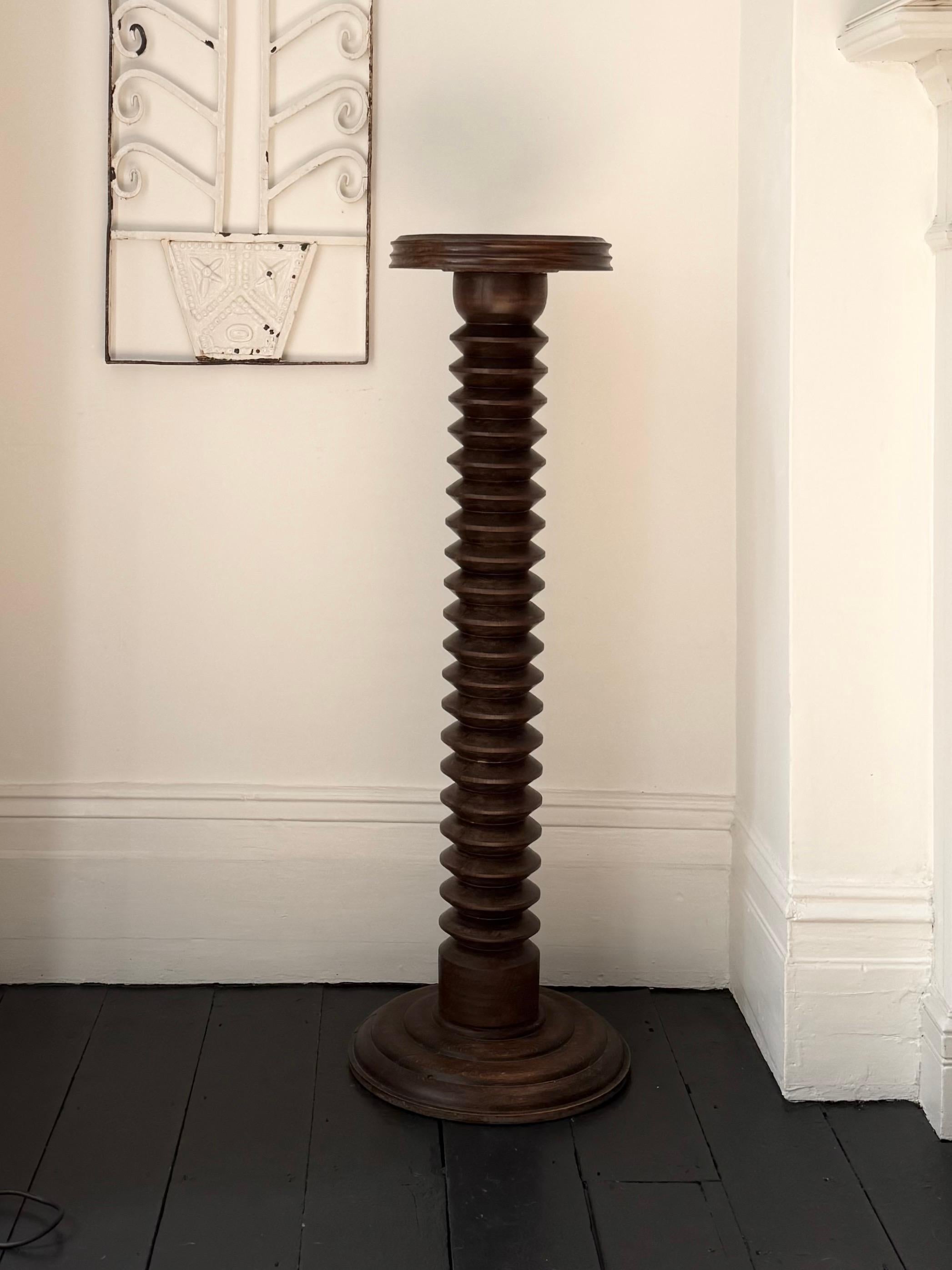 A turned wood pedestal or column with circular base and good weight; used to display plants or other objects. First half twentieth century, found in England. Art deco or modernist in style and reminiscent of the work of Charles Dudouyt (France,