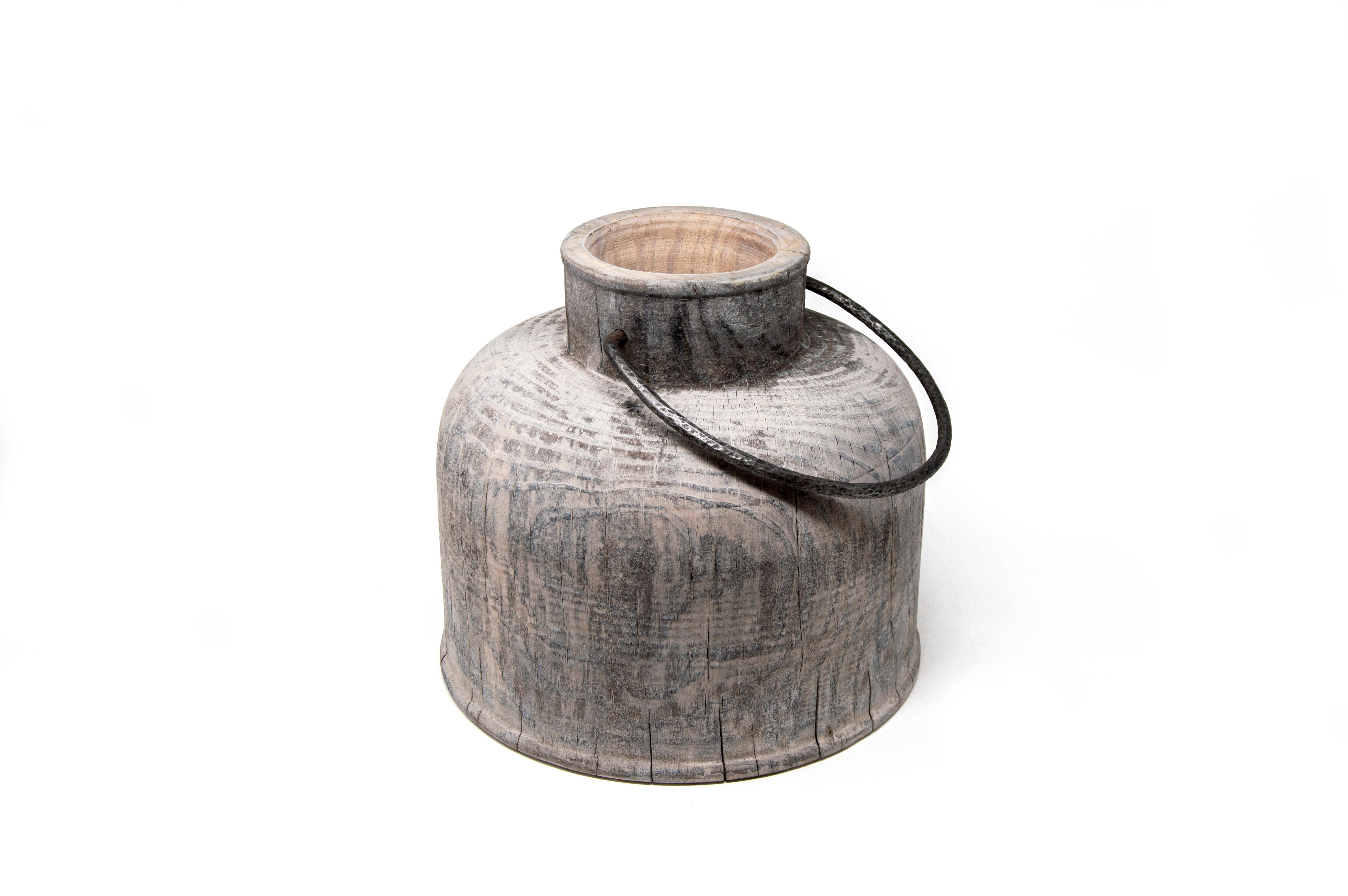 This pine wood vase is designed by the couple Setsu&Shinobu Ito and handmade by the artistic woodturner Lorenzo Franceschinis for Hands on Design. It is inspired by the ancient steel milk containers and the surface finish is made from titanium