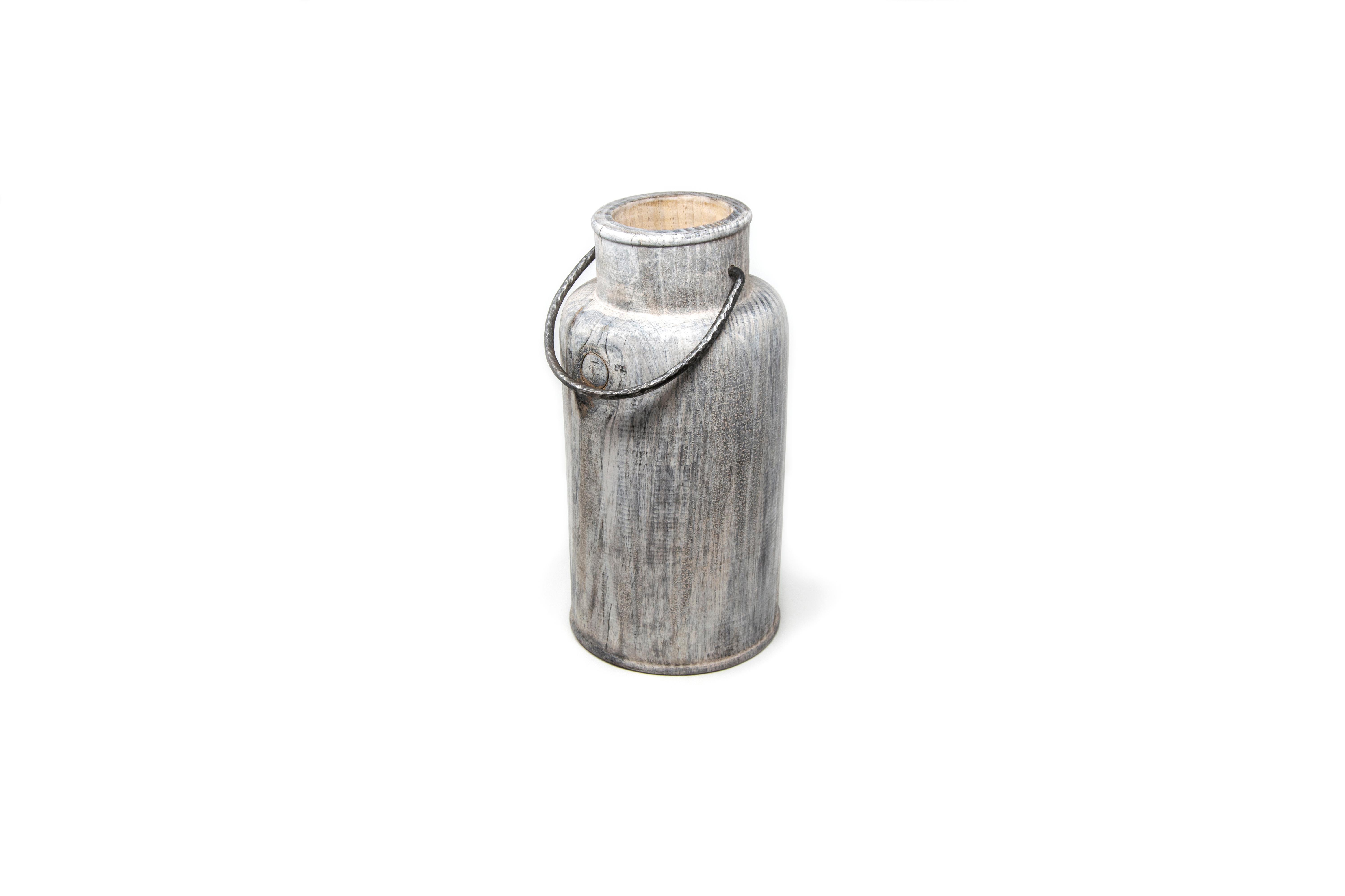 This pine wood vase is designed by the couple Setsu & Shinobu Ito and handmade by the artistic woodturner Lorenzo Franceschinis for Hands on Design. It is inspired by the ancient steel milk containers and the surface finish is made from titanium