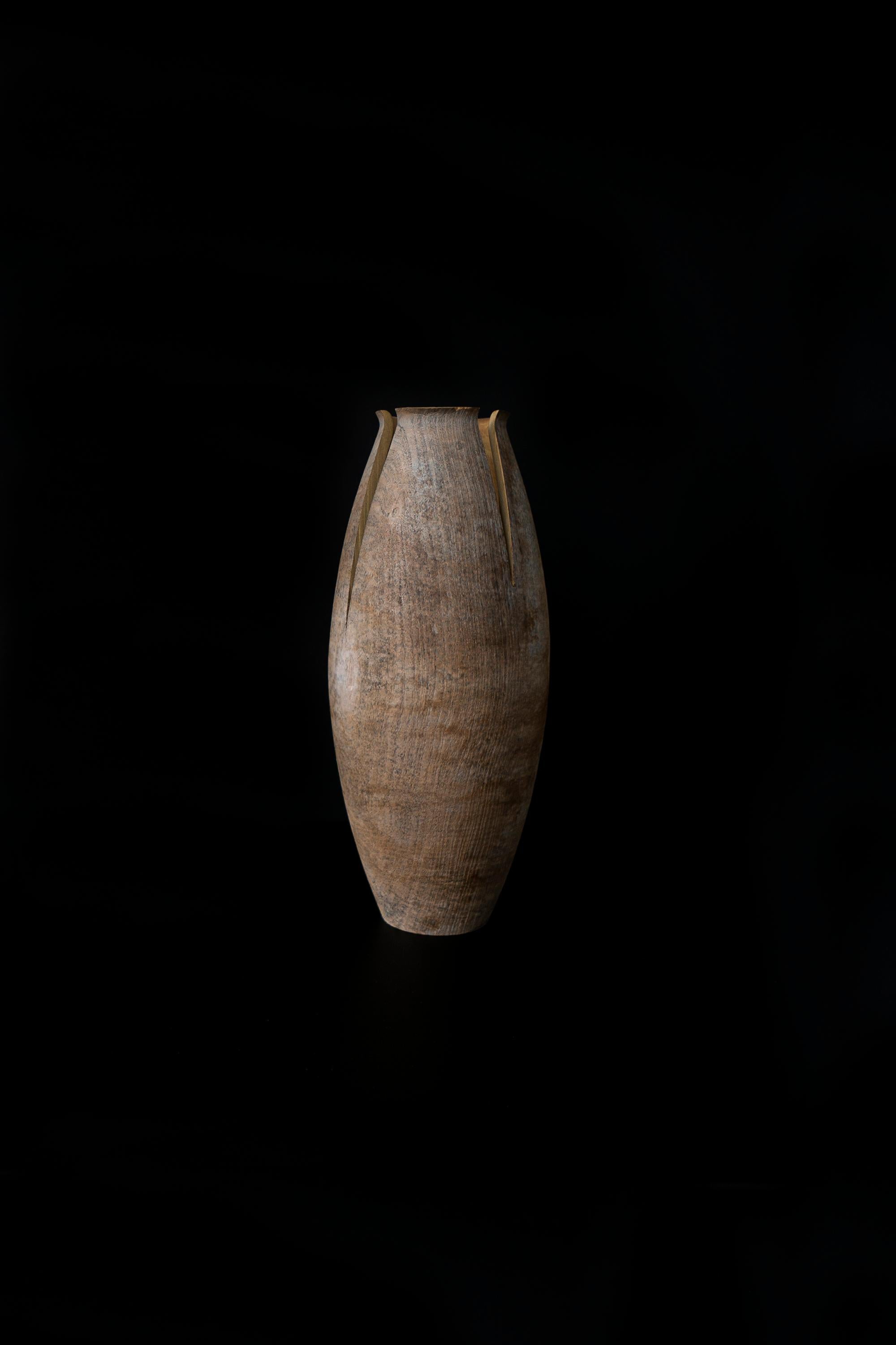 Tomahawk is an essential yet beautiful vase made of mulberry wood stained with a titanium oxide-based finish. 
The simple shape is split by an ax blow that characterizes the image. This vase comes in three different shapes, designed by the Italian
