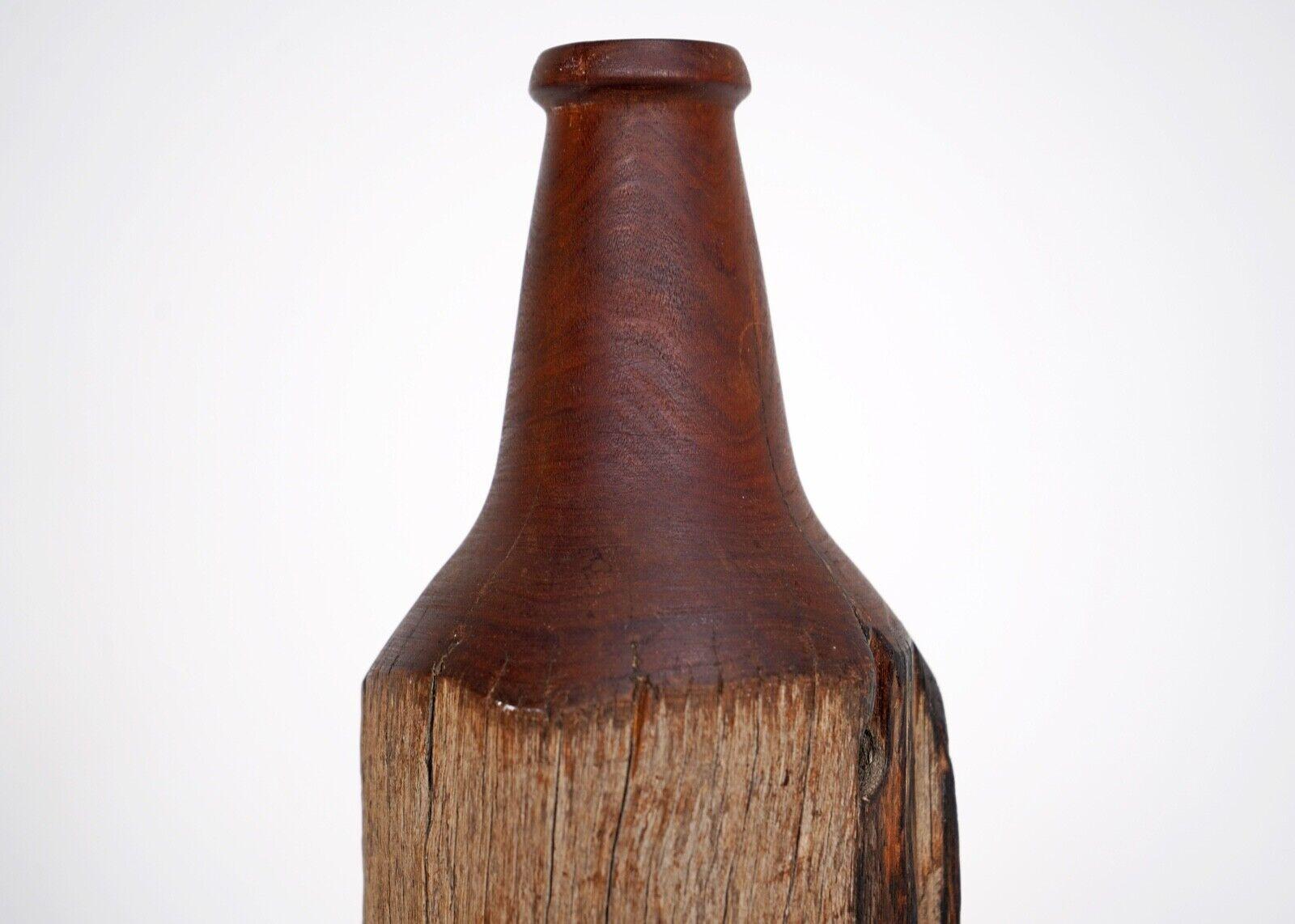 A turned wood sculpture of a bottle.
Possibly made from drift wood.
A tactile piece with beautiful form.
 Signed and dated on the base. Dated 94.
 
Dimensions
Height - 20cm
Diameter 10.5cm.