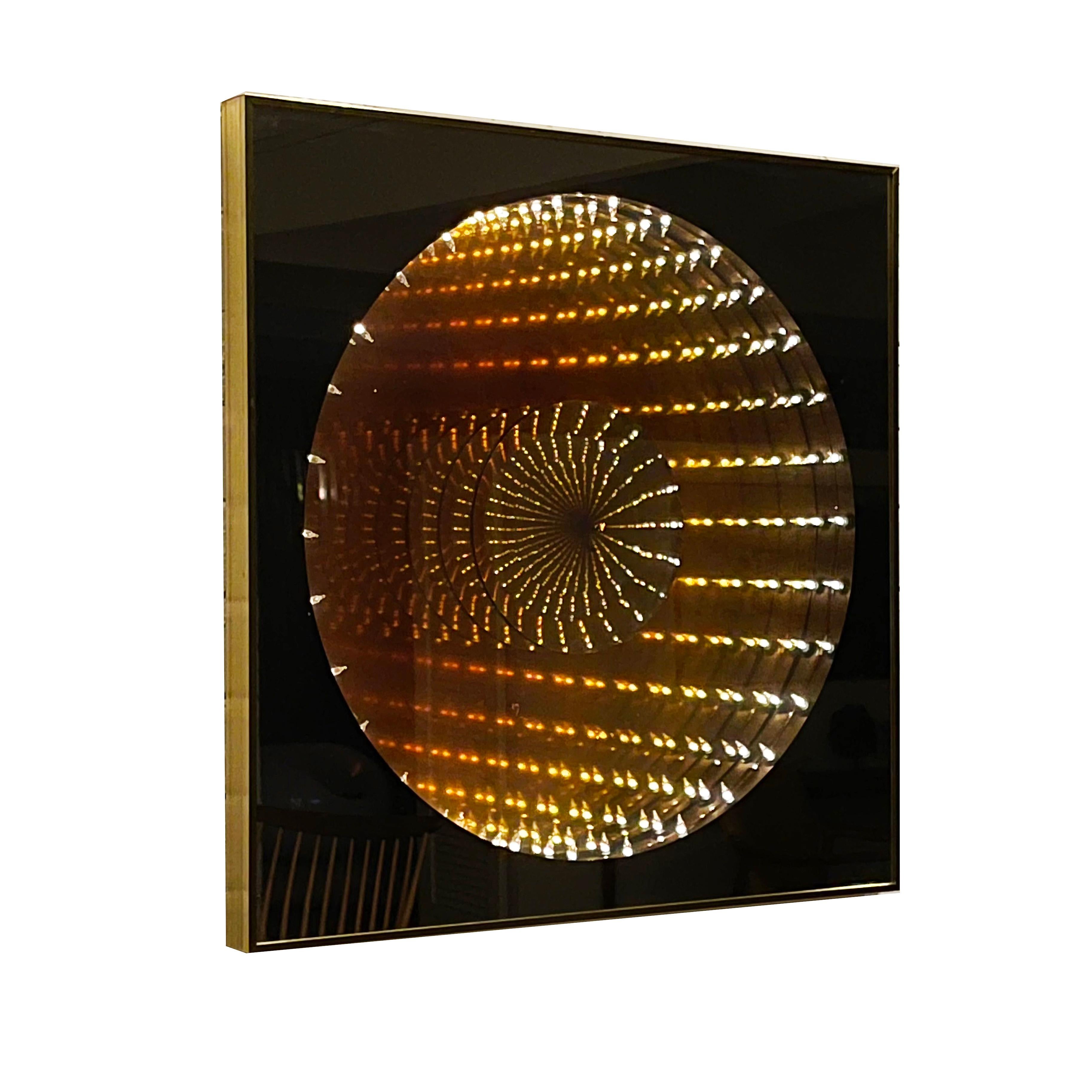 This compelling piece by Turner is both mirror and artwork. A two-way mirror set in a brass frame in front of a surround of tiny lights which, when illuminated, create the illusion of great depth.

 Can be hung to orient wire to either side.